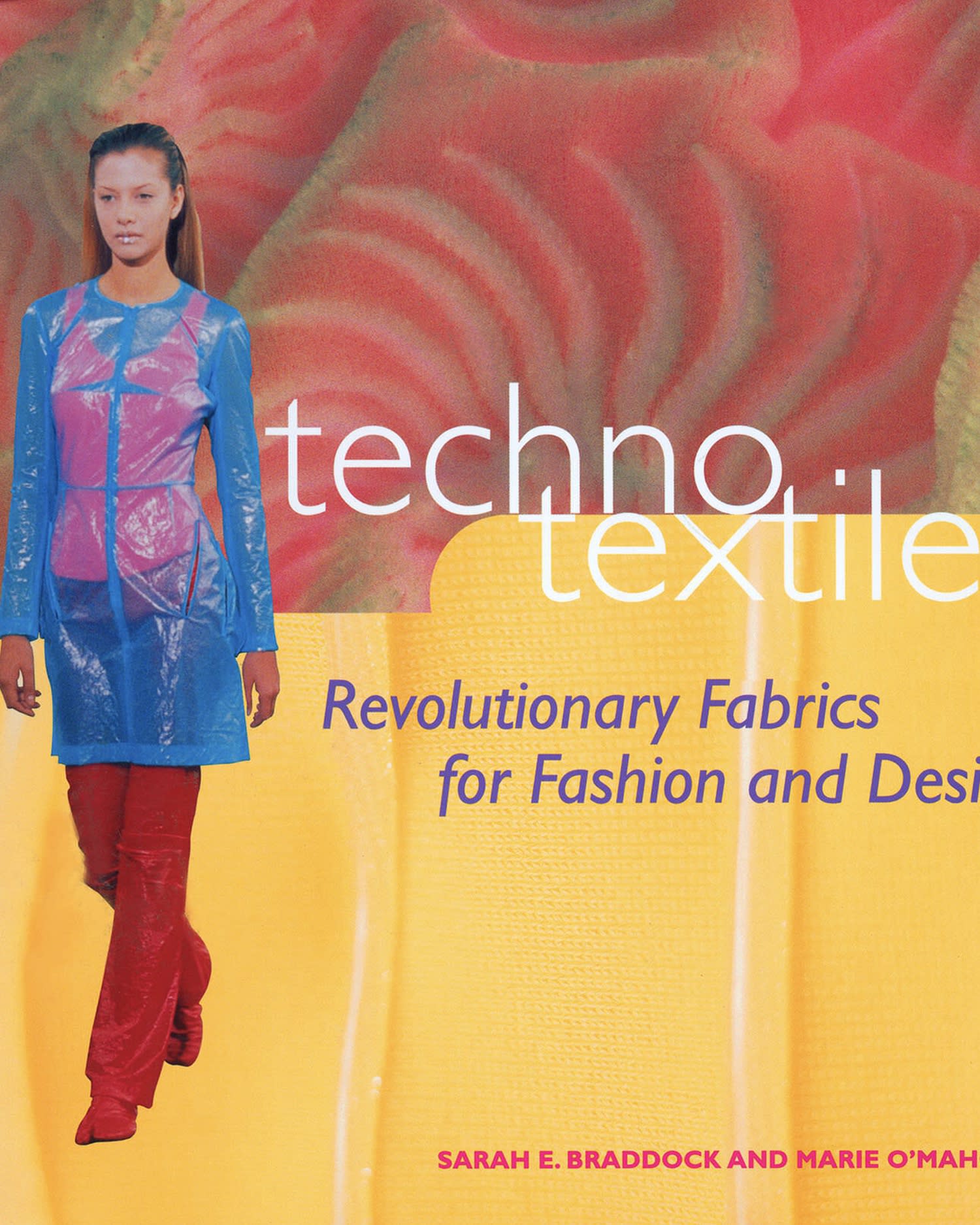 The front cover of a book called Techno Textiles depicting a woman wearing a red long pants and a blue rain jacket with a red and yellow background. 