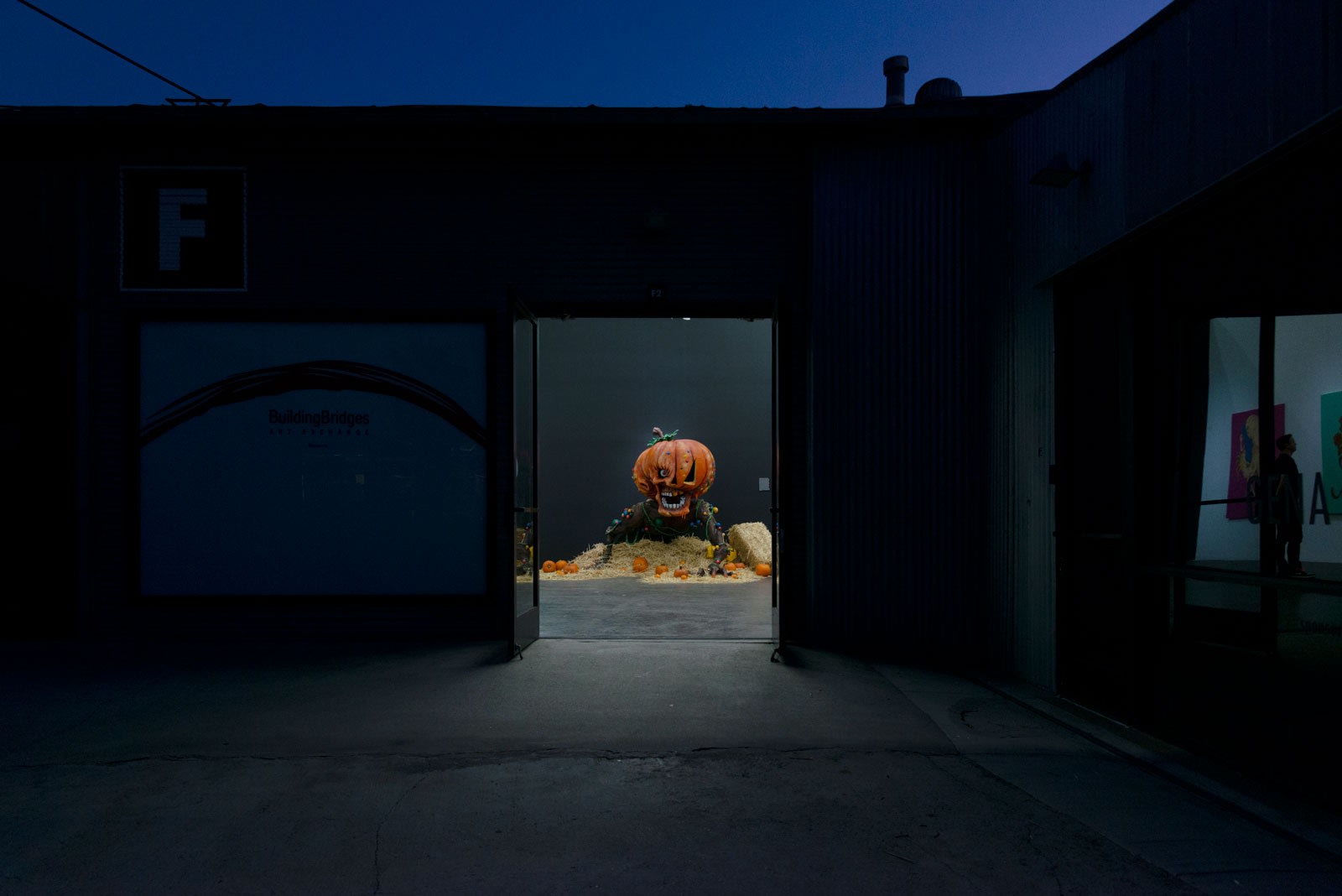 Outside photo looking into gallery with the Giant Pumpkin sculpture in focus