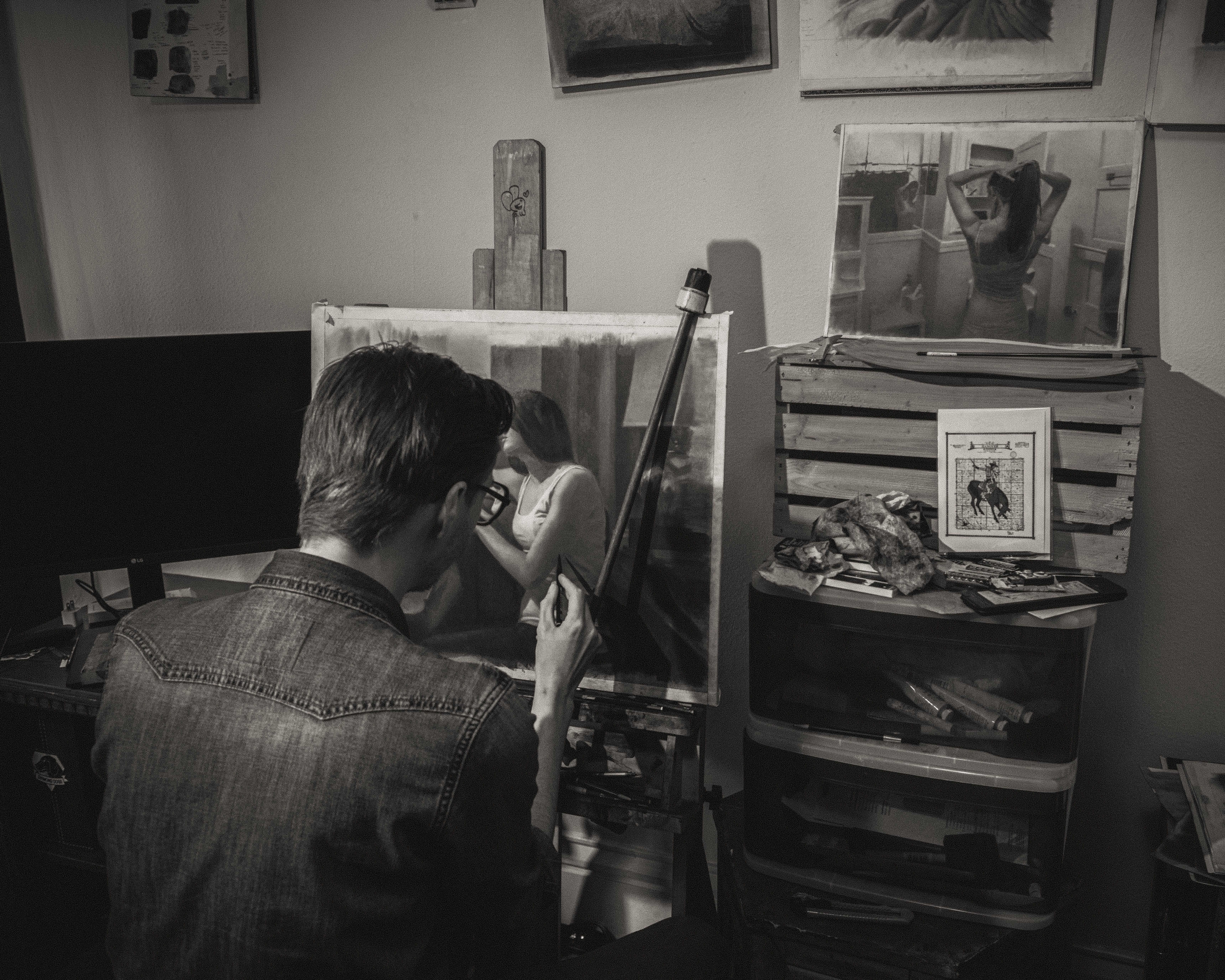 Black and white photo of Zachary Oldenkamp working in his studio