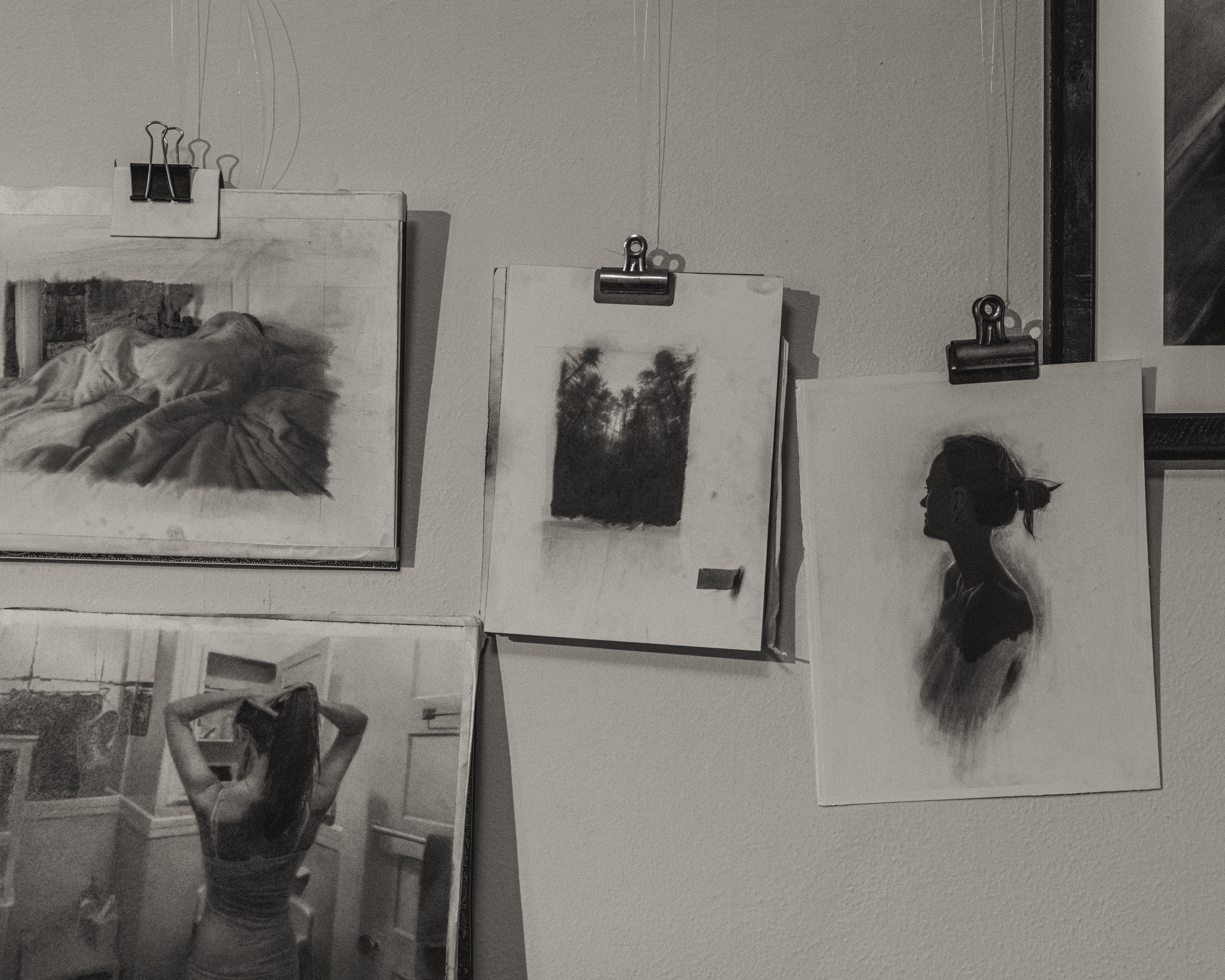 Black and white photo of Zachary Oldenkamp drawings on a wall