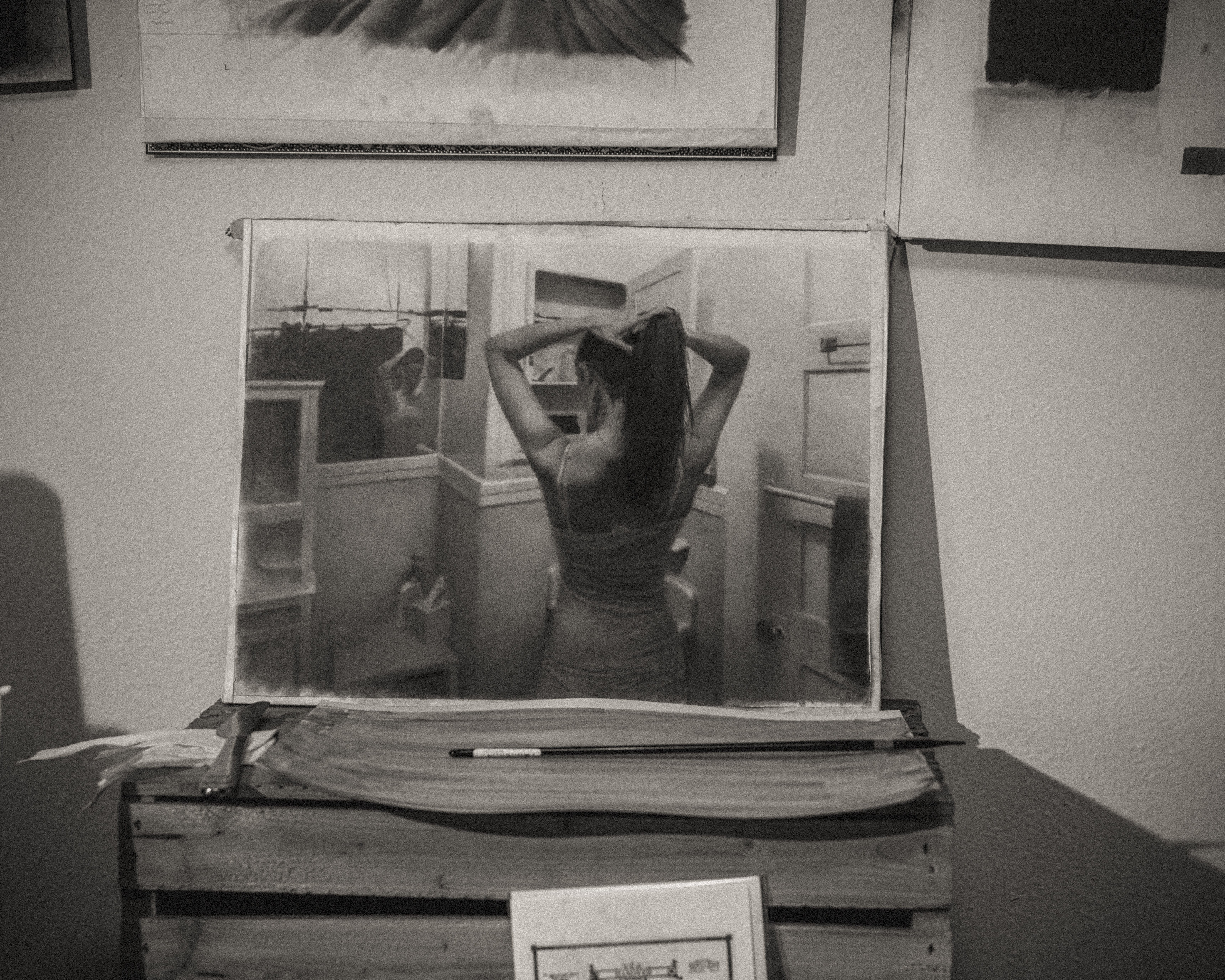 Black and White photo of a Zachary Oldenkamp drawing on an easel