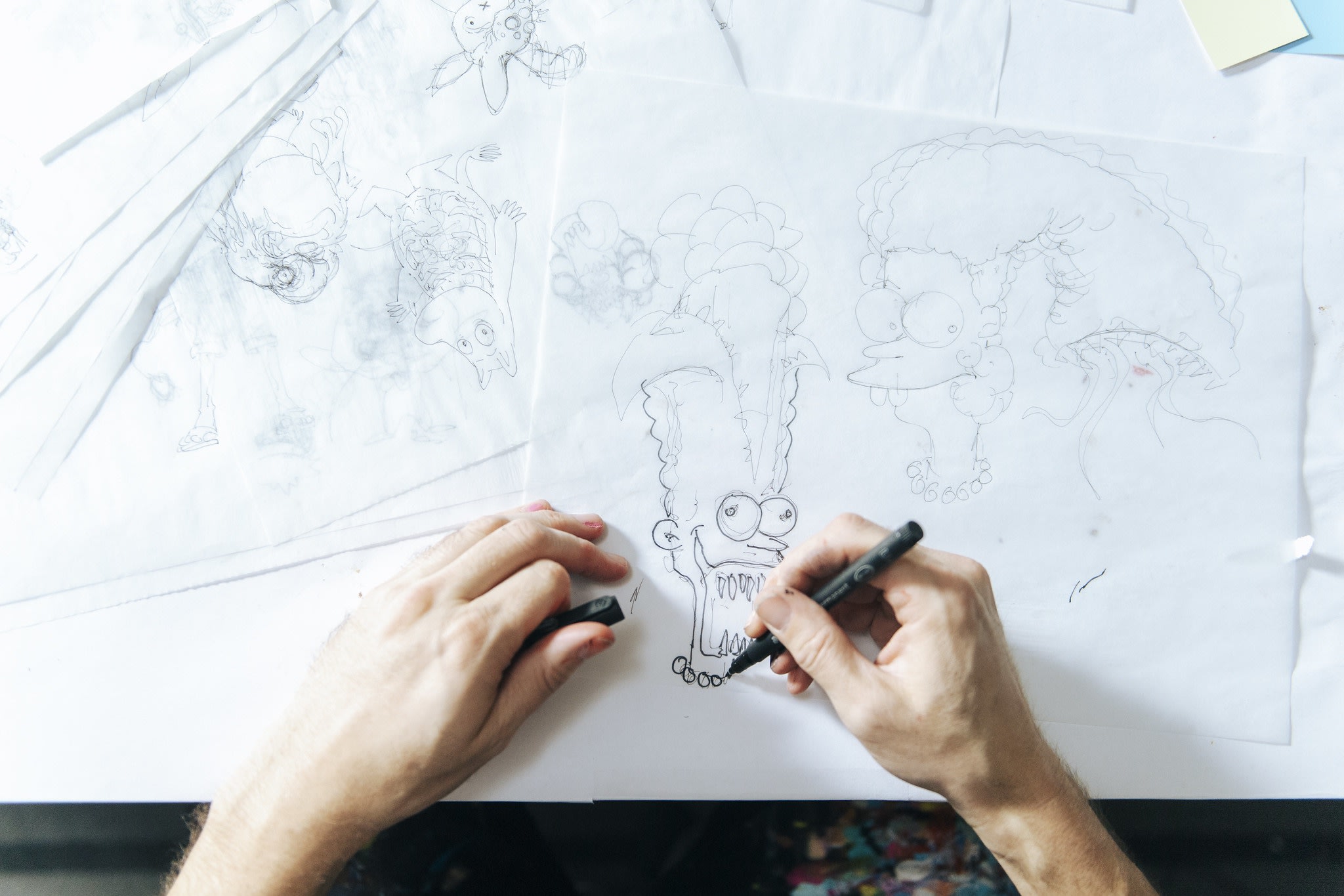 Studio visit with artist Alex Pardee, close up of the artist drawing.
