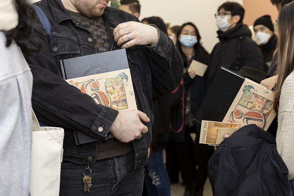 people holding books in the crowd