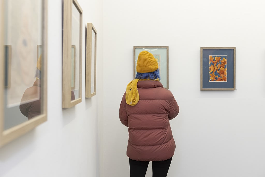 back of a person looking at Felicia Chiao drawings