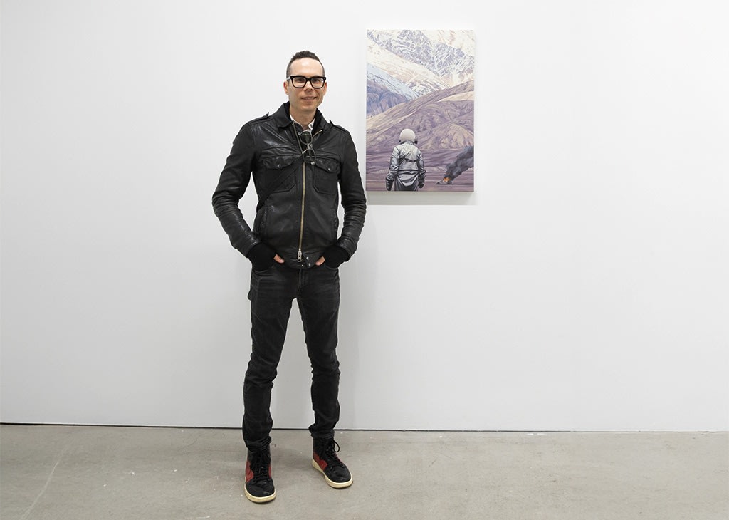 photo of artist Scott Listfield posing next to his piece 