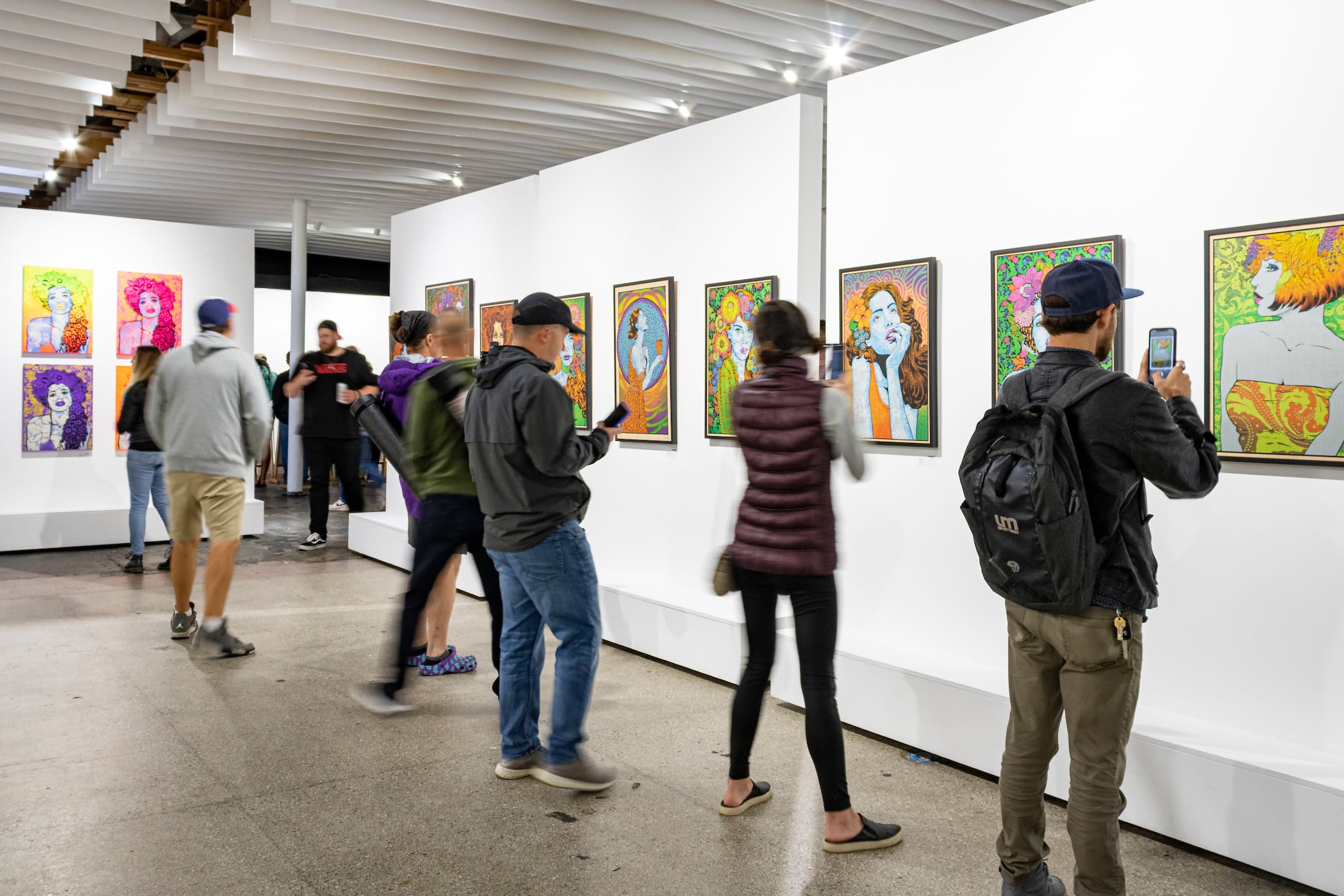 Photograph of a crowd admiring Chuck Sperry's artwork.