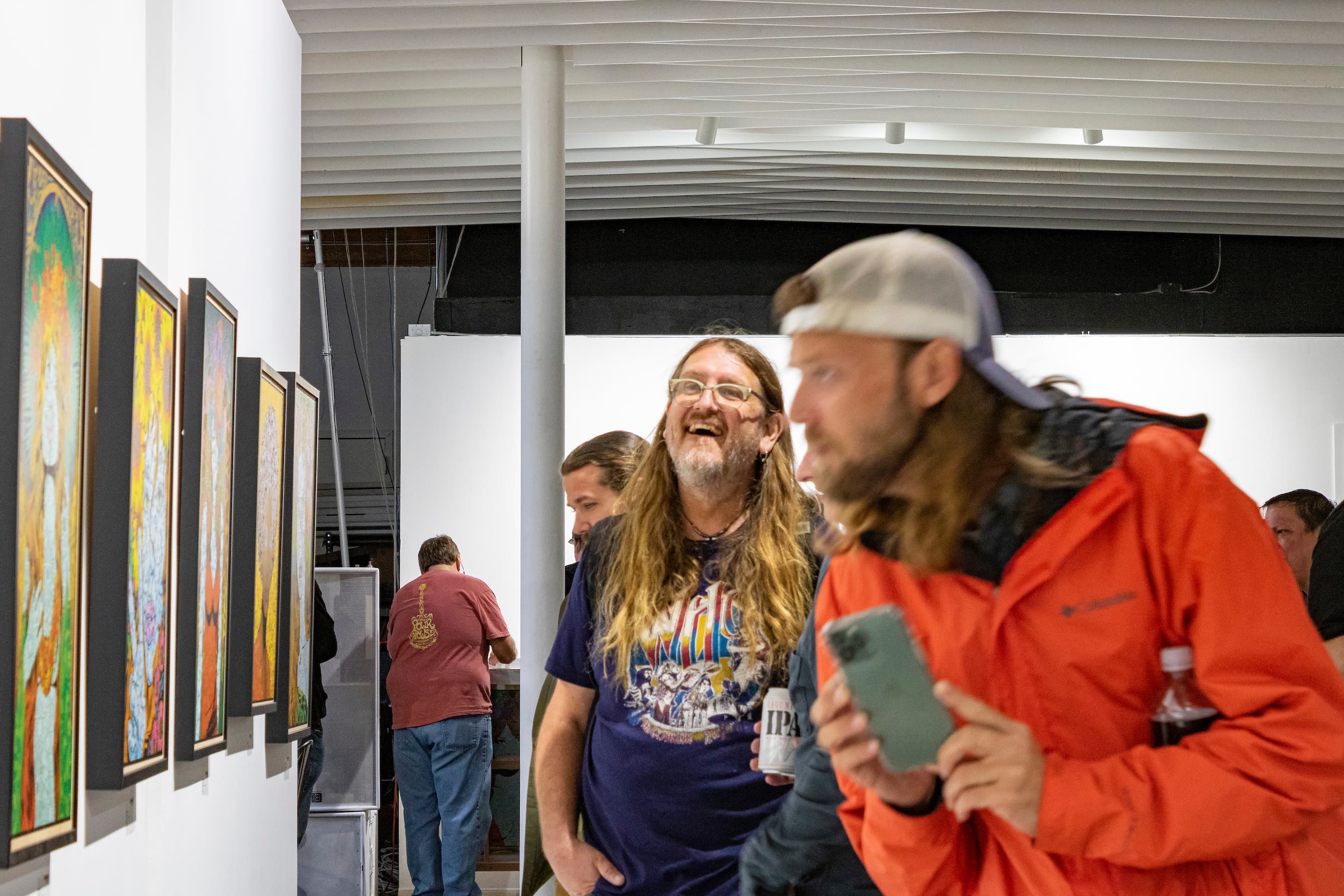 Photograph of a crowd admiring Chuck Sperry's artwork.