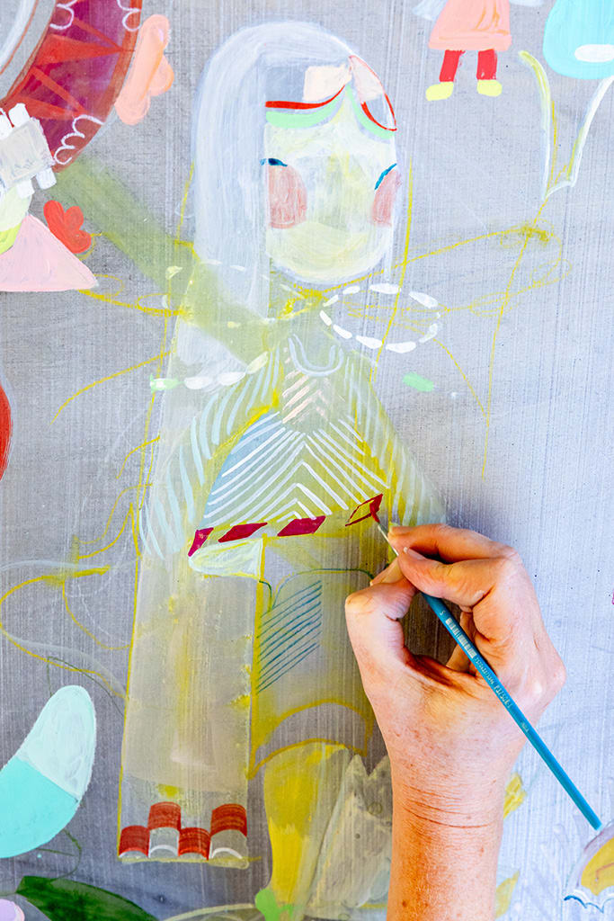 A closeup of Kelly Tunstall's hand in the act of painting.