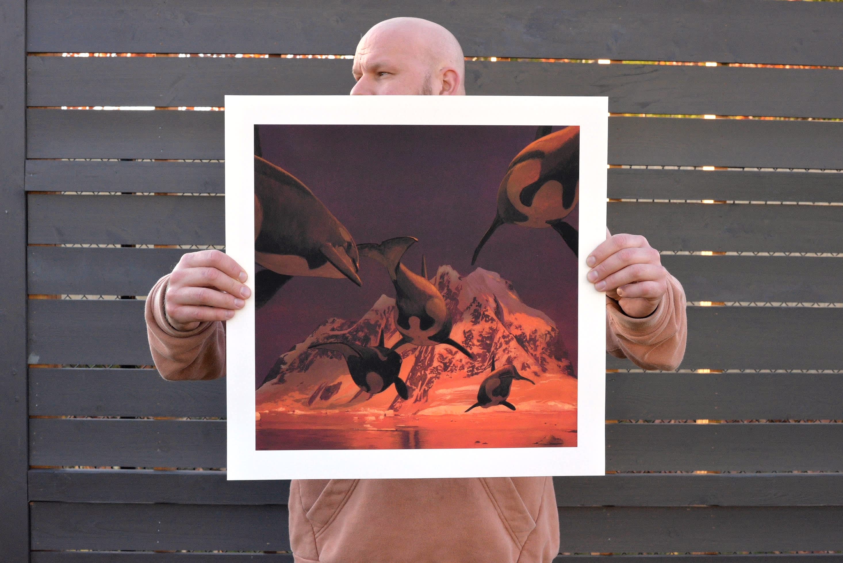 Chris Austin holding a print of 