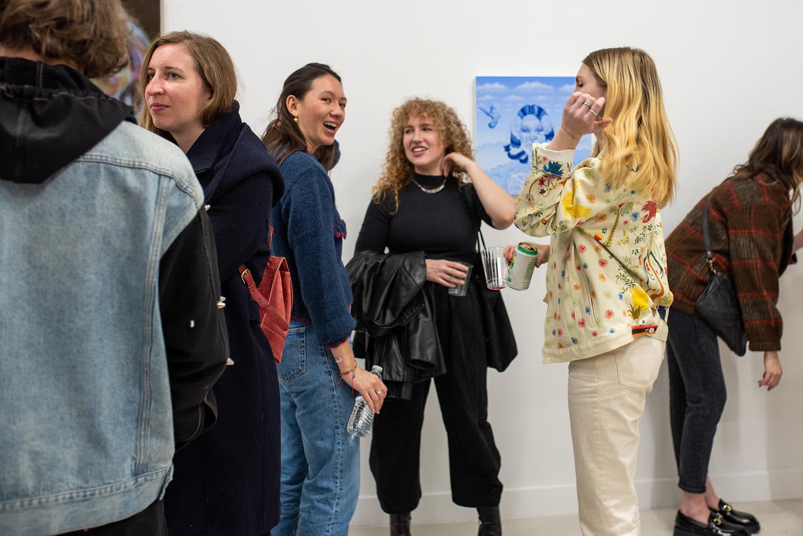 photo of a crowd of people in the art gallery