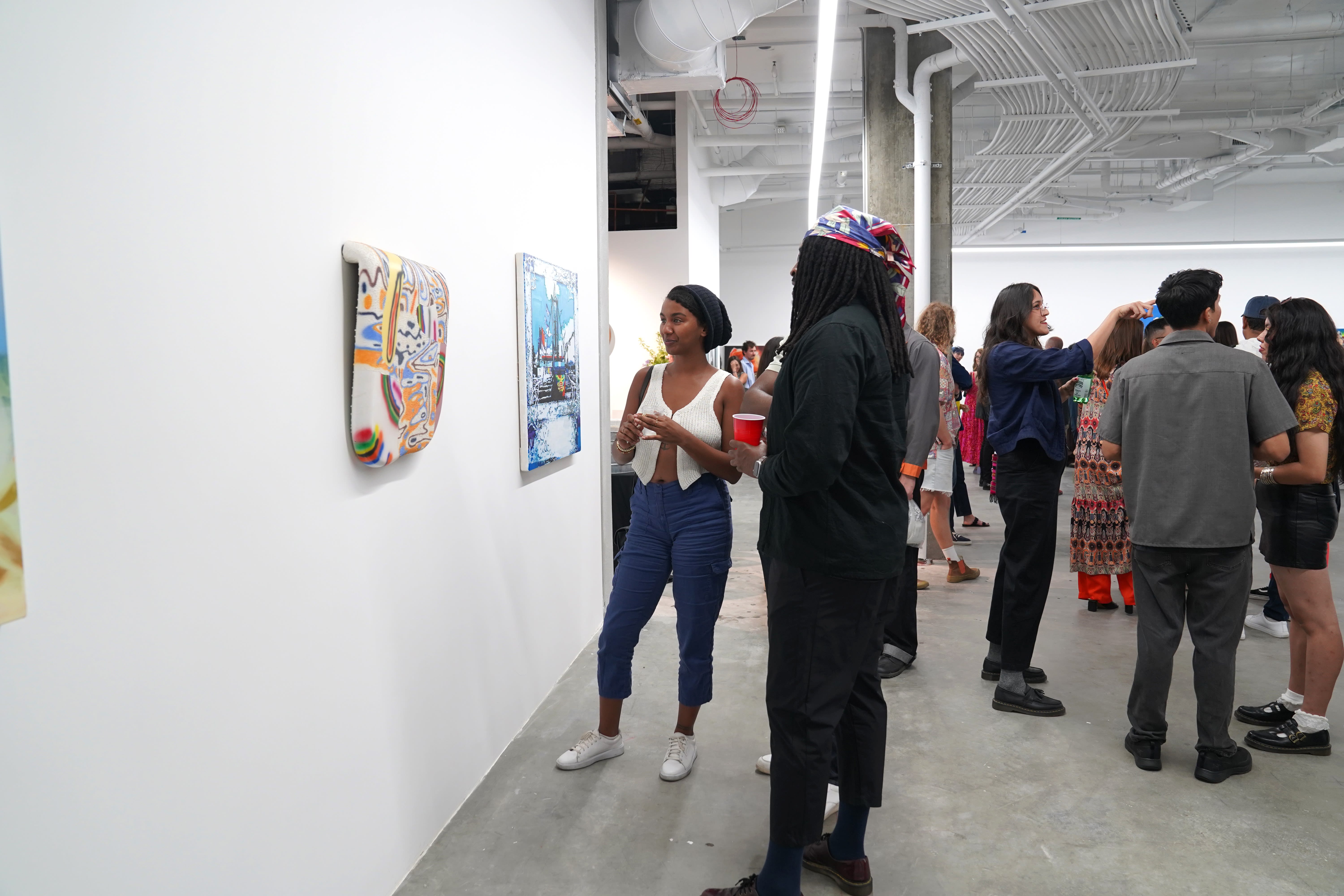 photo of a crowd of people in the art gallery