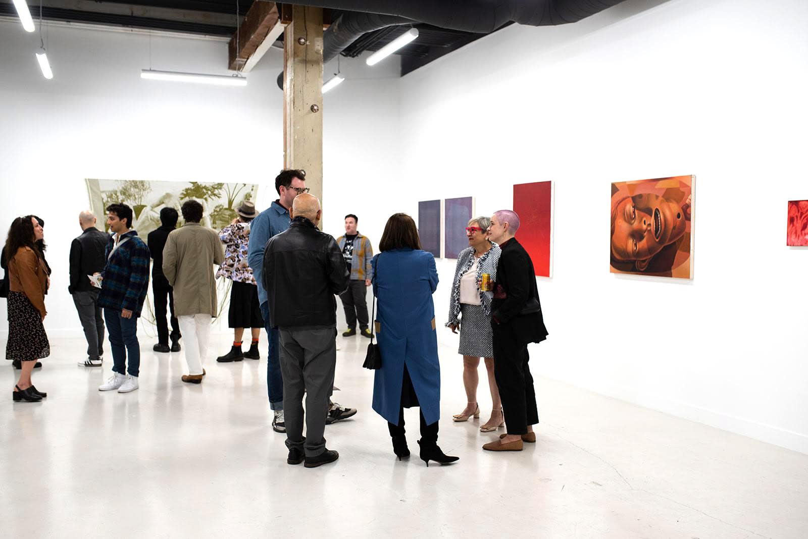 photo of a crowd of people in the art gallery