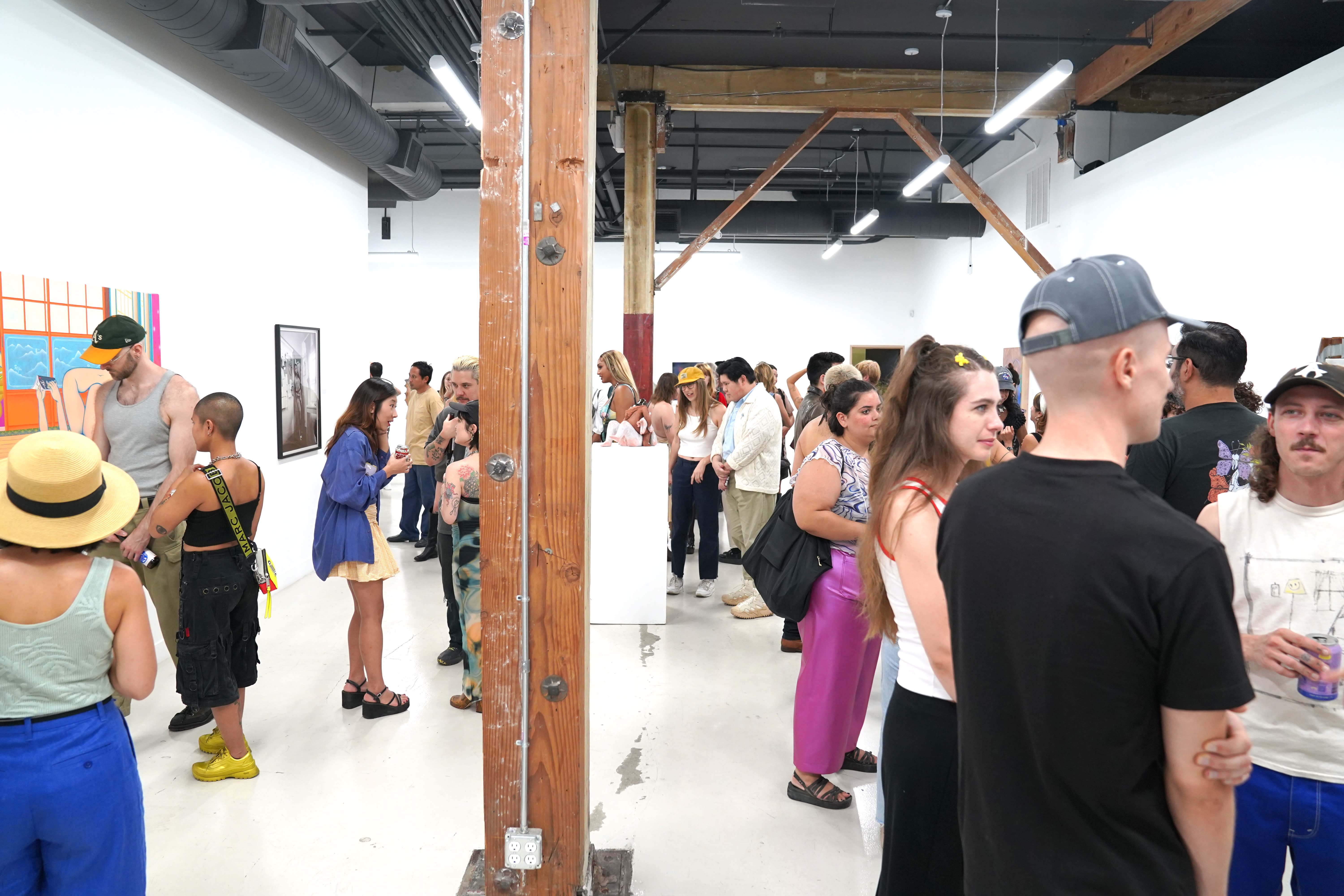 photo of an art gallery full of people
