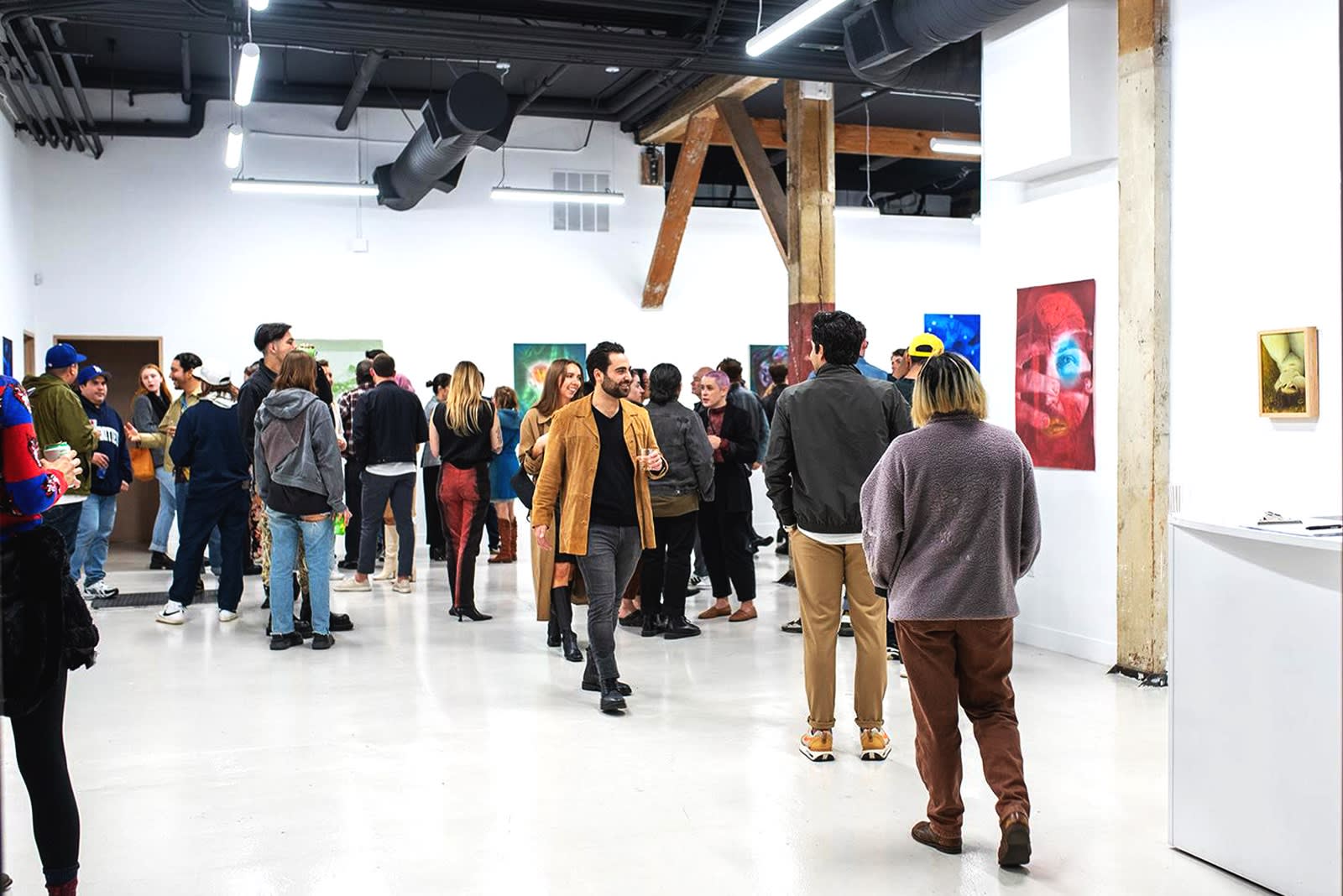 photo of a crowd of people in the art gallery