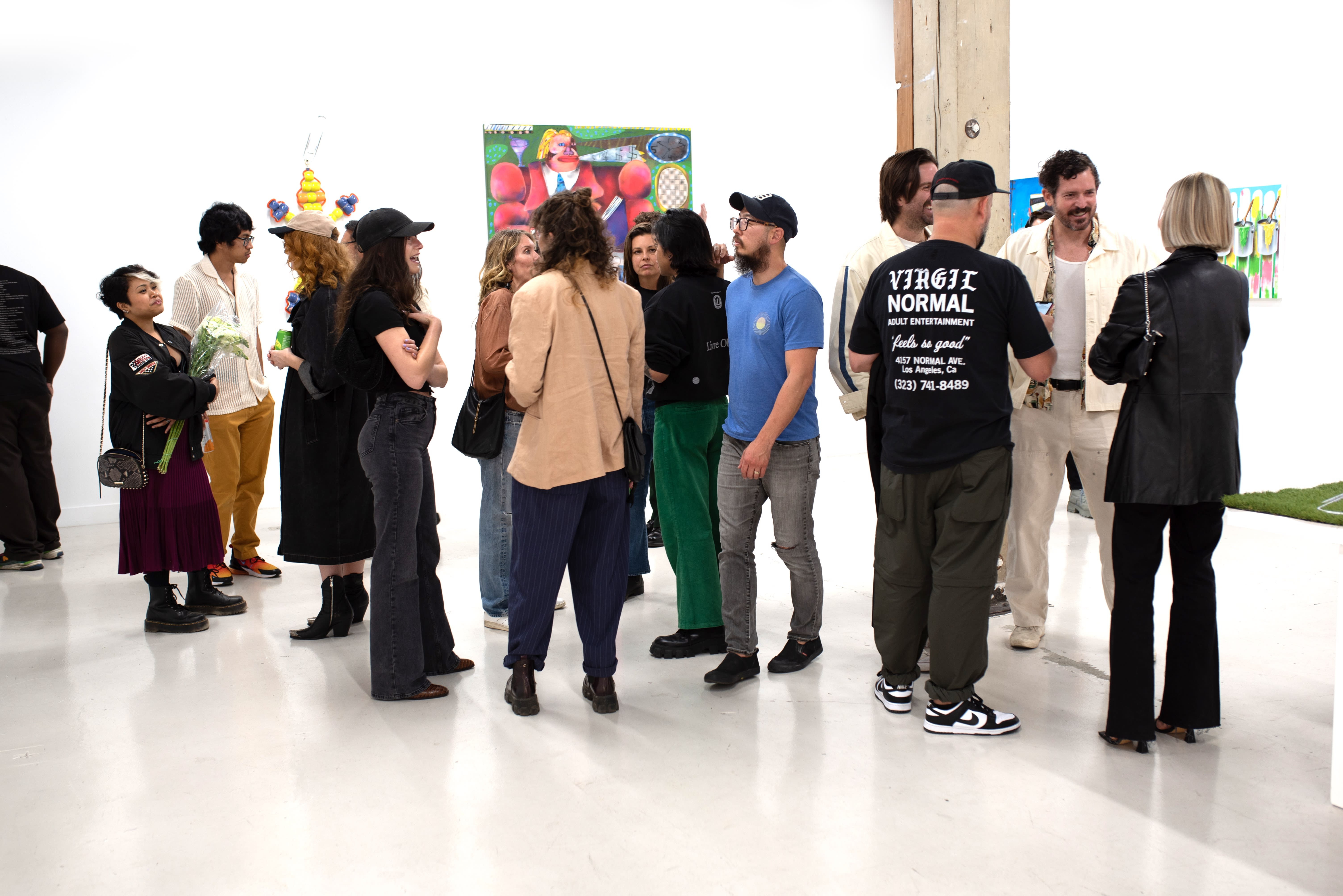 photo of a crowd of people in an art gallery