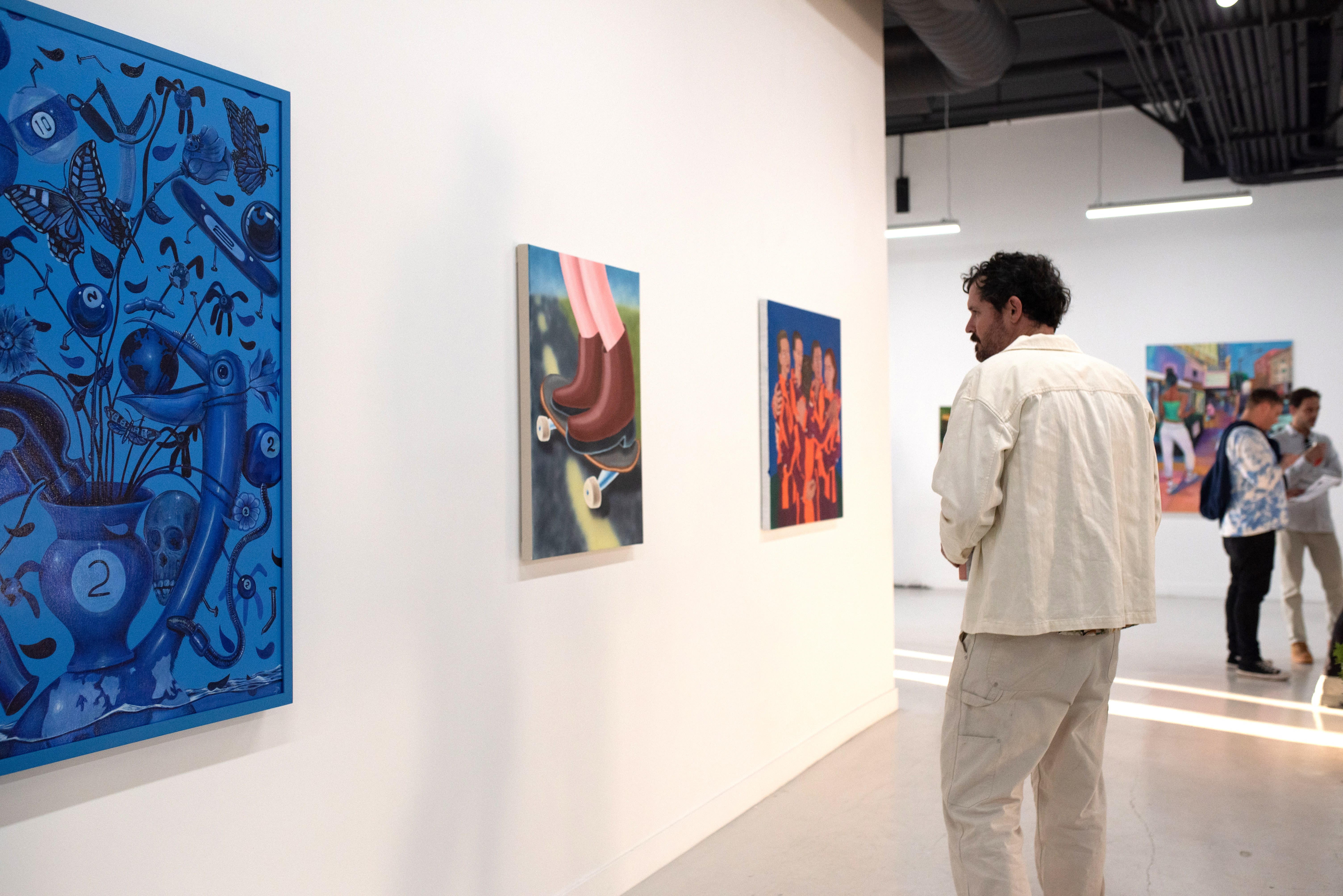 photo of a crowd of people in an art gallery