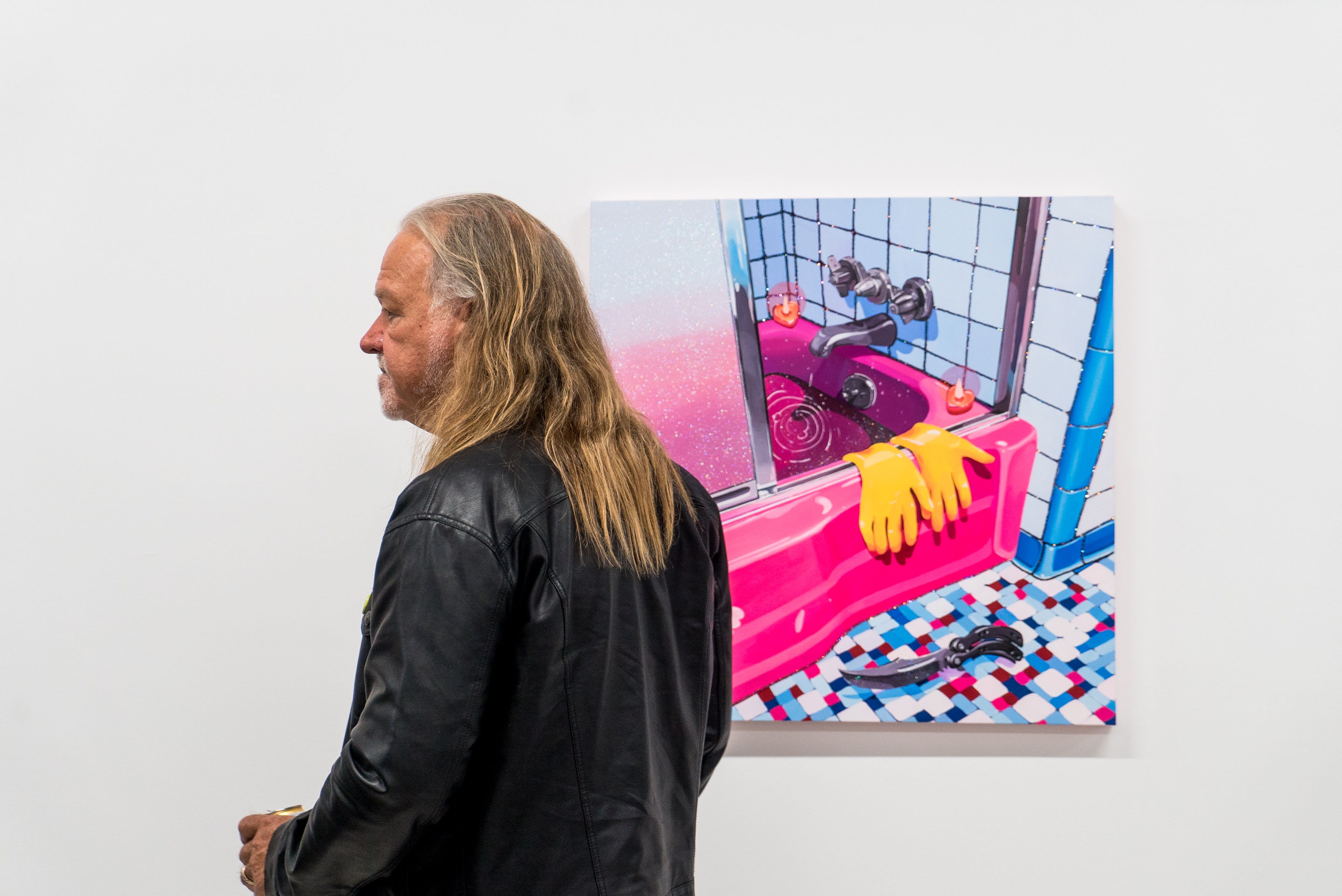 photo of a man standing in frontof Rachael Tarravechia's pink bath tub painting