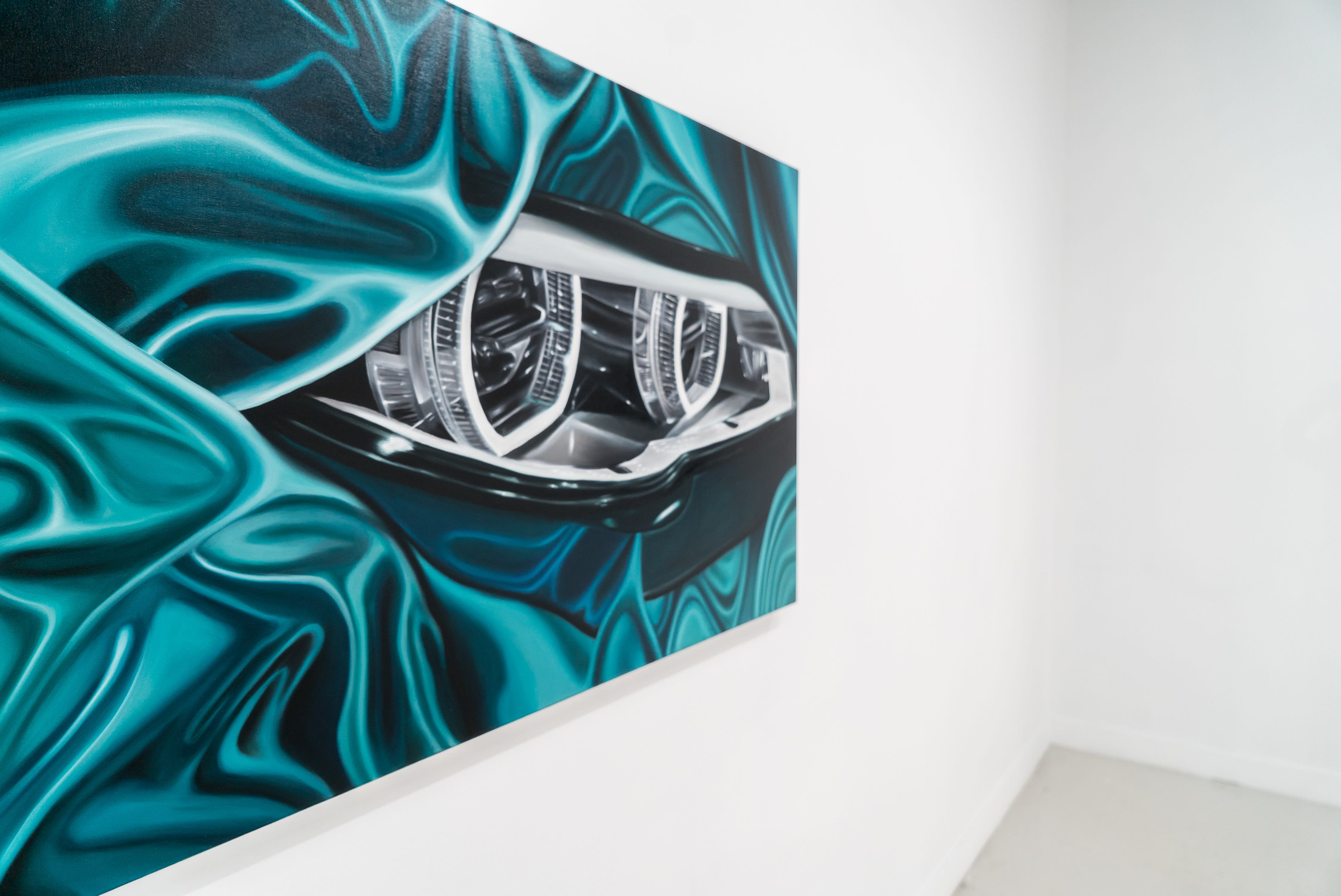 photo of a painting of a blue car light by douglas de souza