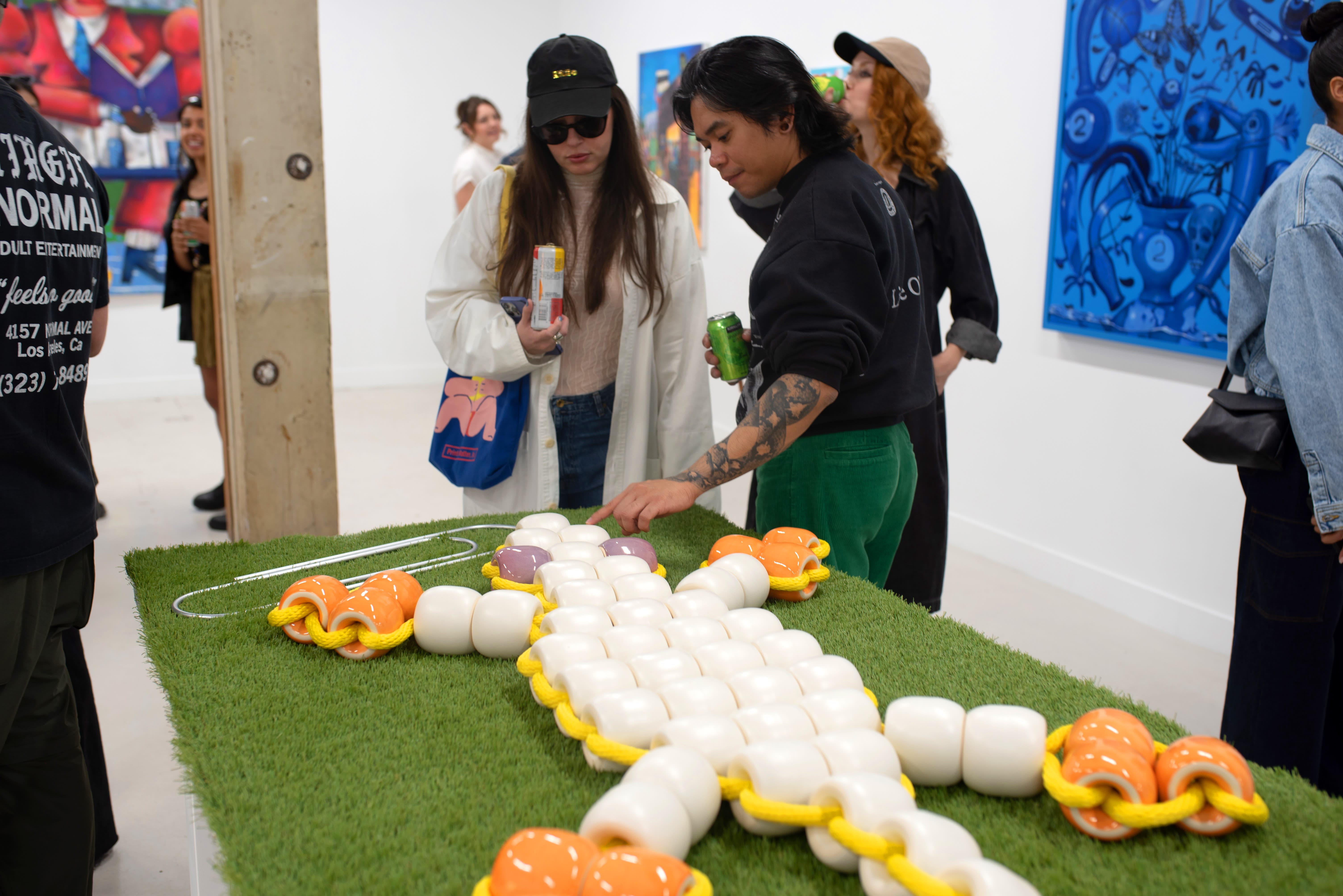 photo of a crowd of people in an art gallery