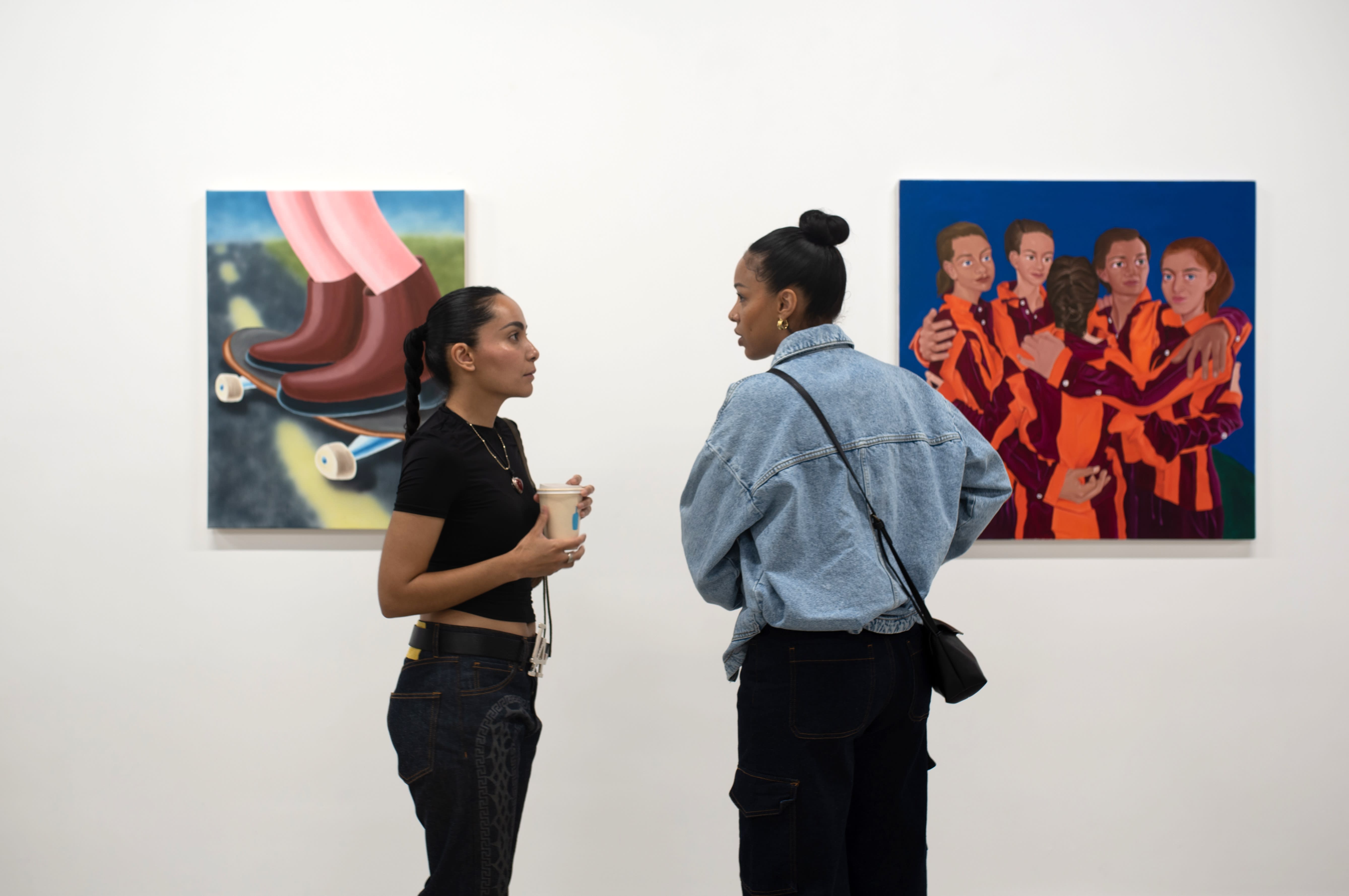 photo of a crowd of people in an art gallery