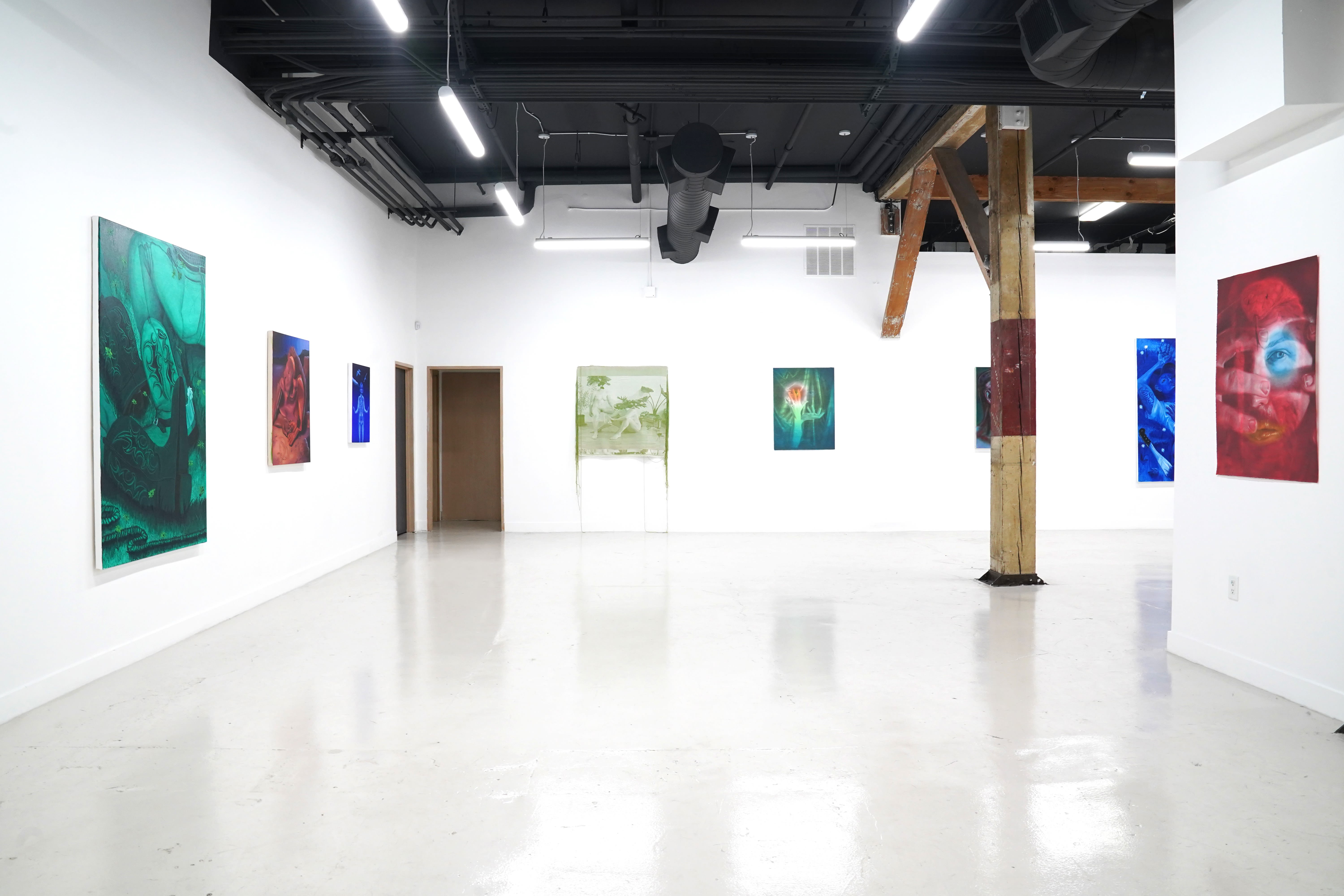 photo of the gallery with paintings hangiing on the wall