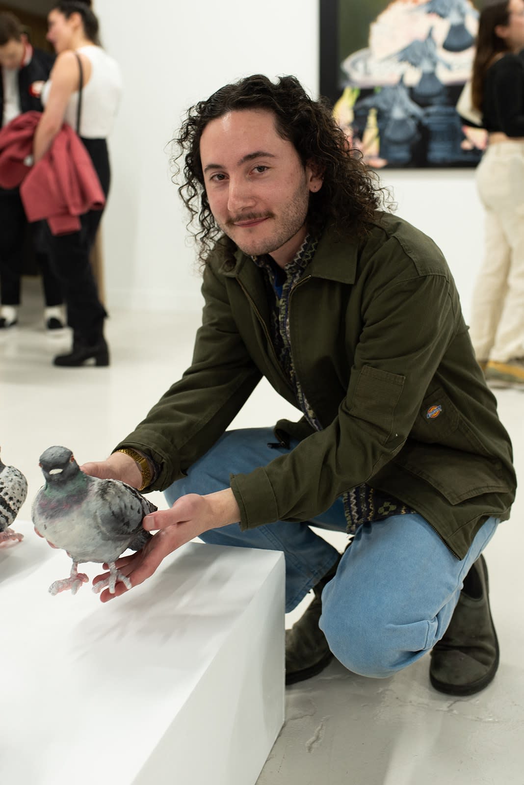 photo of michael diamond holding one of his pigeon scultpures
