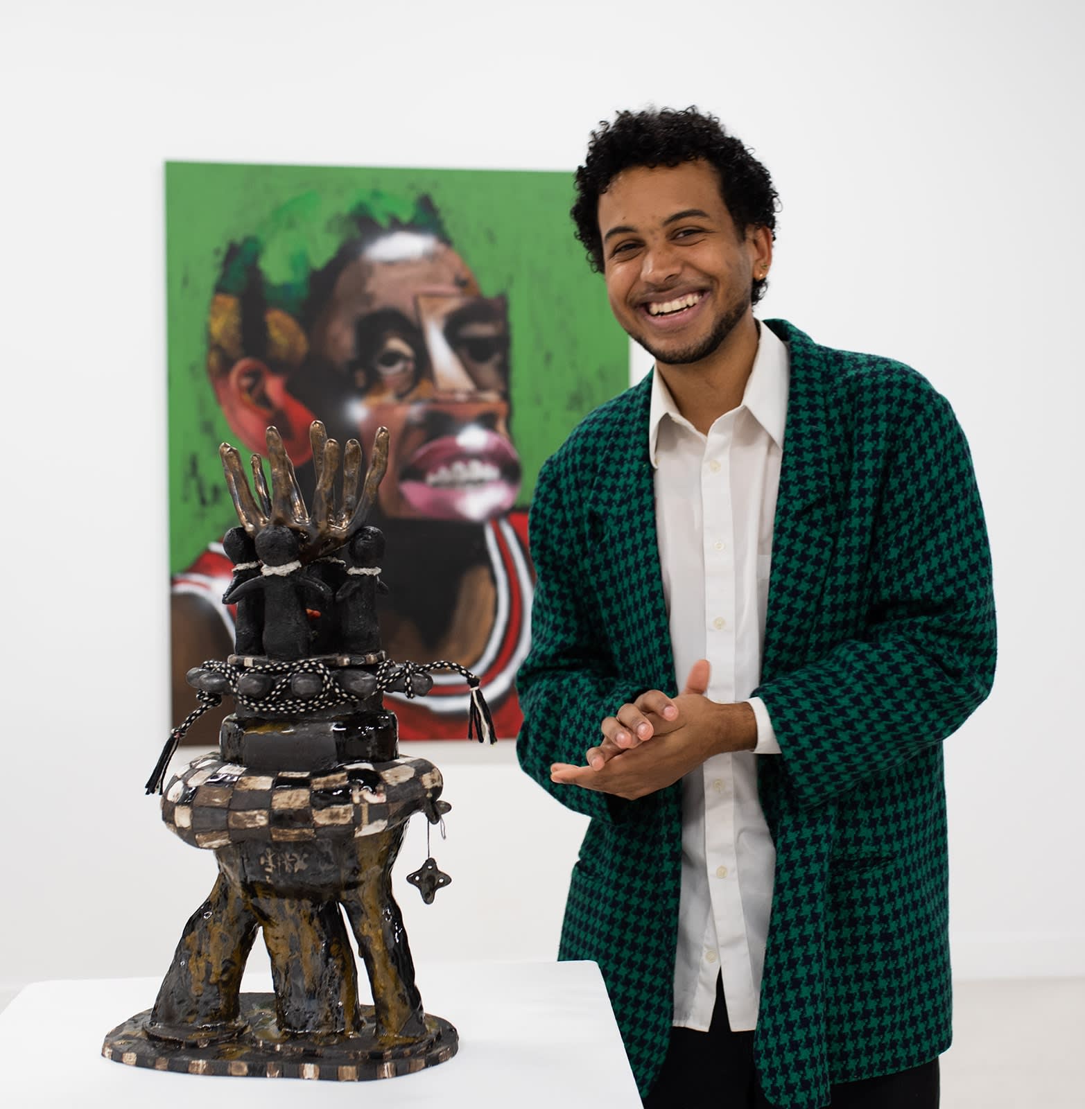 photo of artists Josh Cloud next to his ceramic sculpture