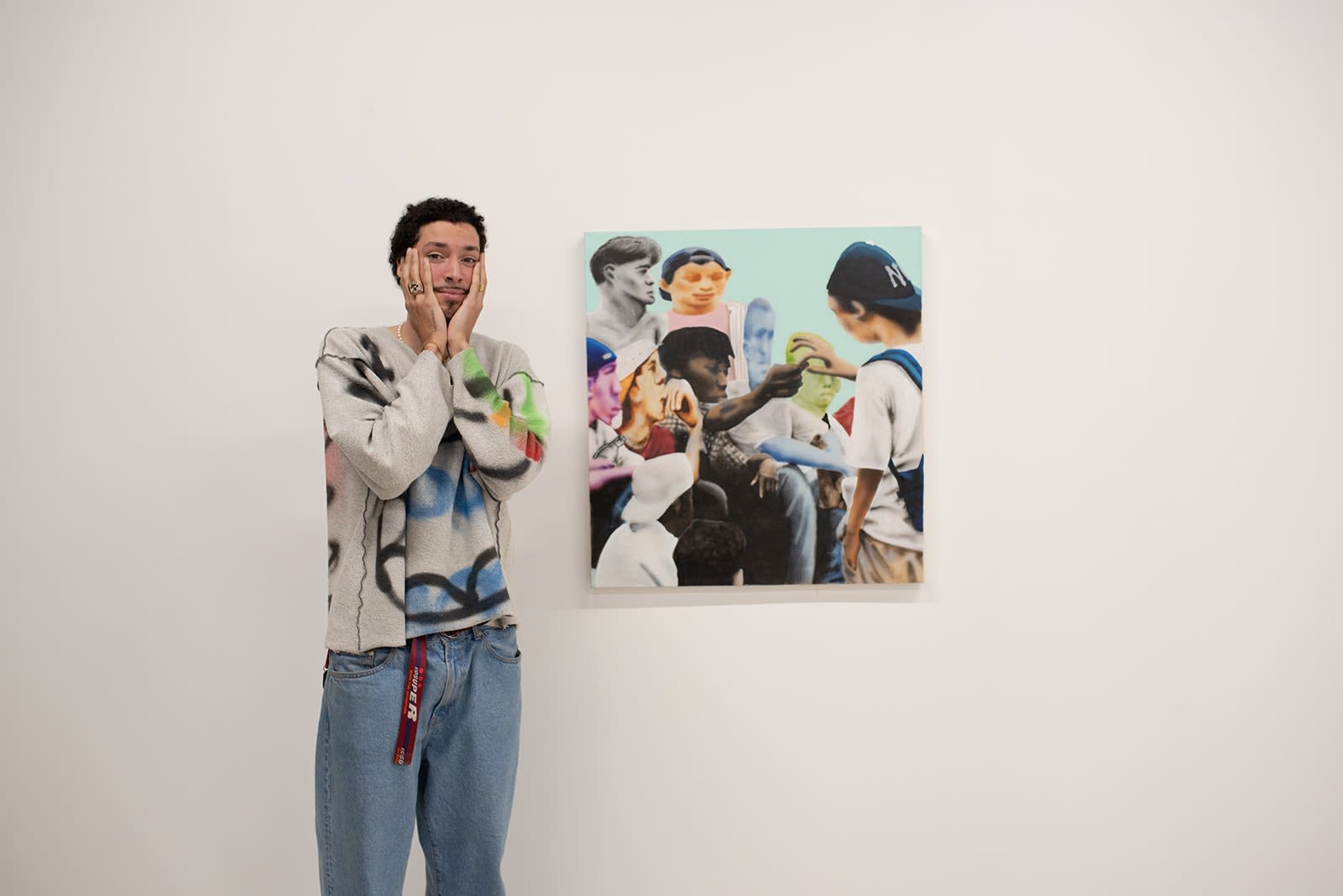 photograph of people inside the gallery surrounded by paintings and artwork