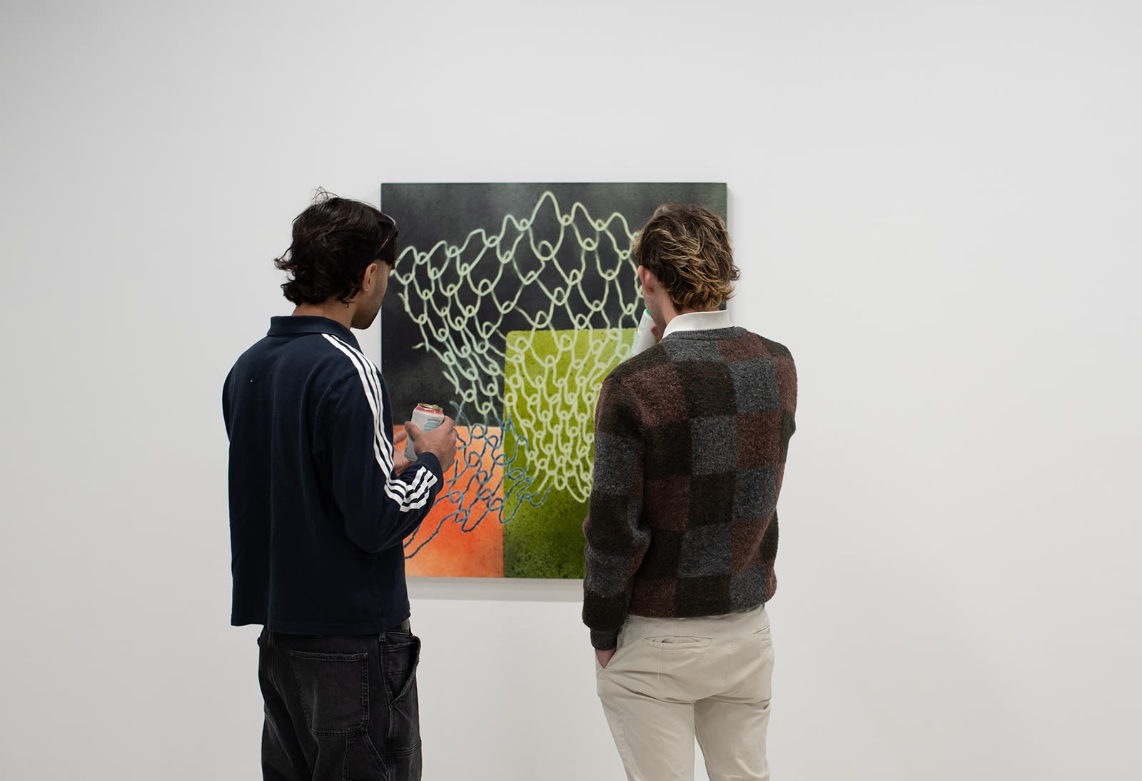 photograph of people inside the gallery surrounded by paintings and artwork