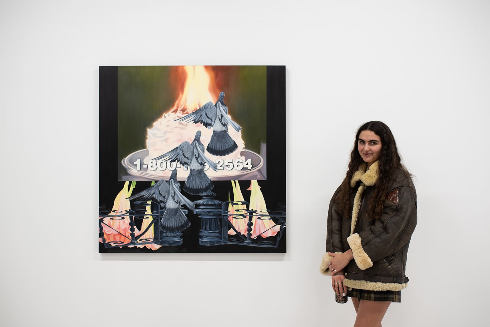 photo of artist Morgan Corbitt standing in front of her painting