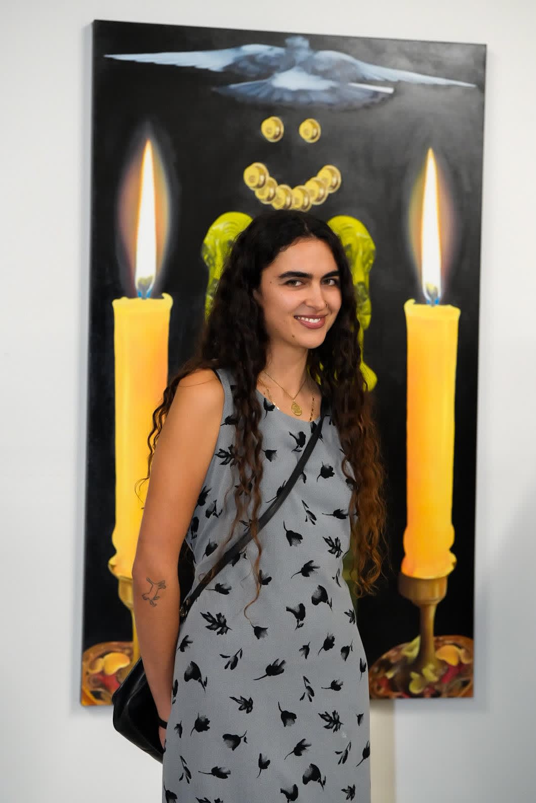 photo of the artist morgan corbitt in front of her painting