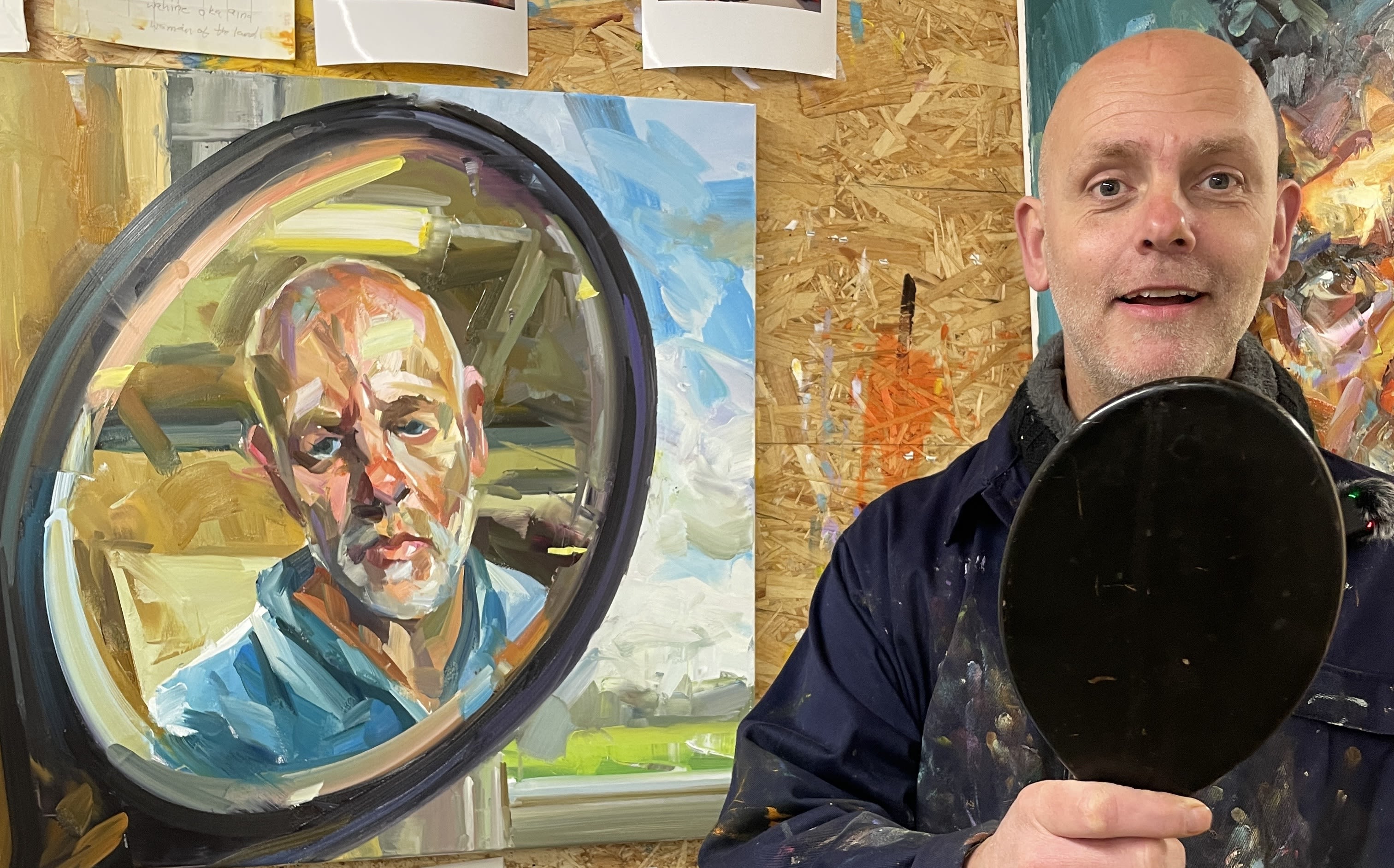 Paul Wright in front of a self portrait