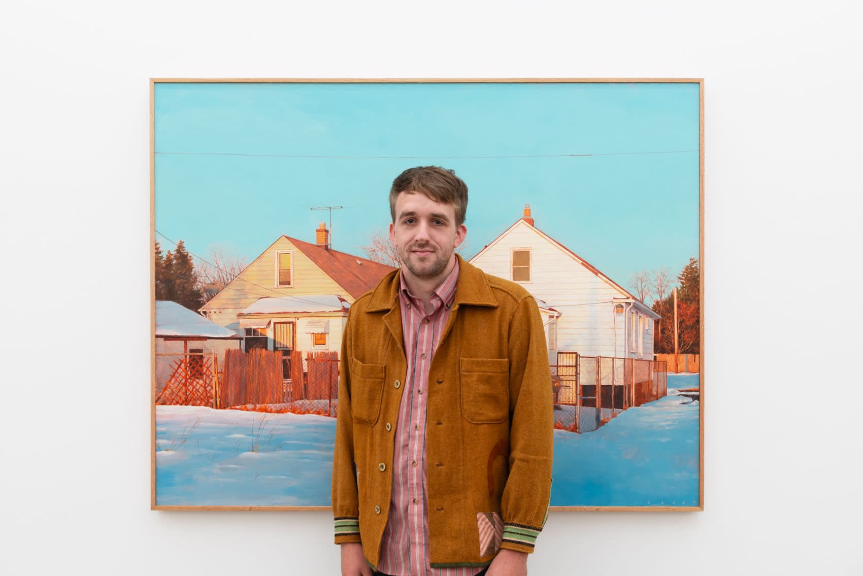 Artist pat Perry stands in front of his painting 