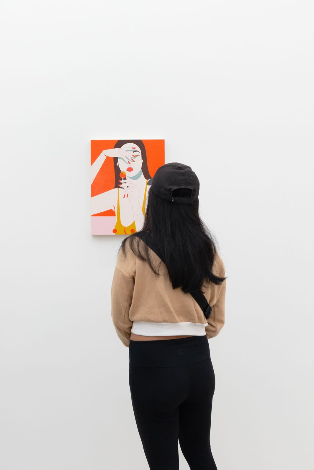 Photo of person looking at Jillian Evelyn's Sucker painting 