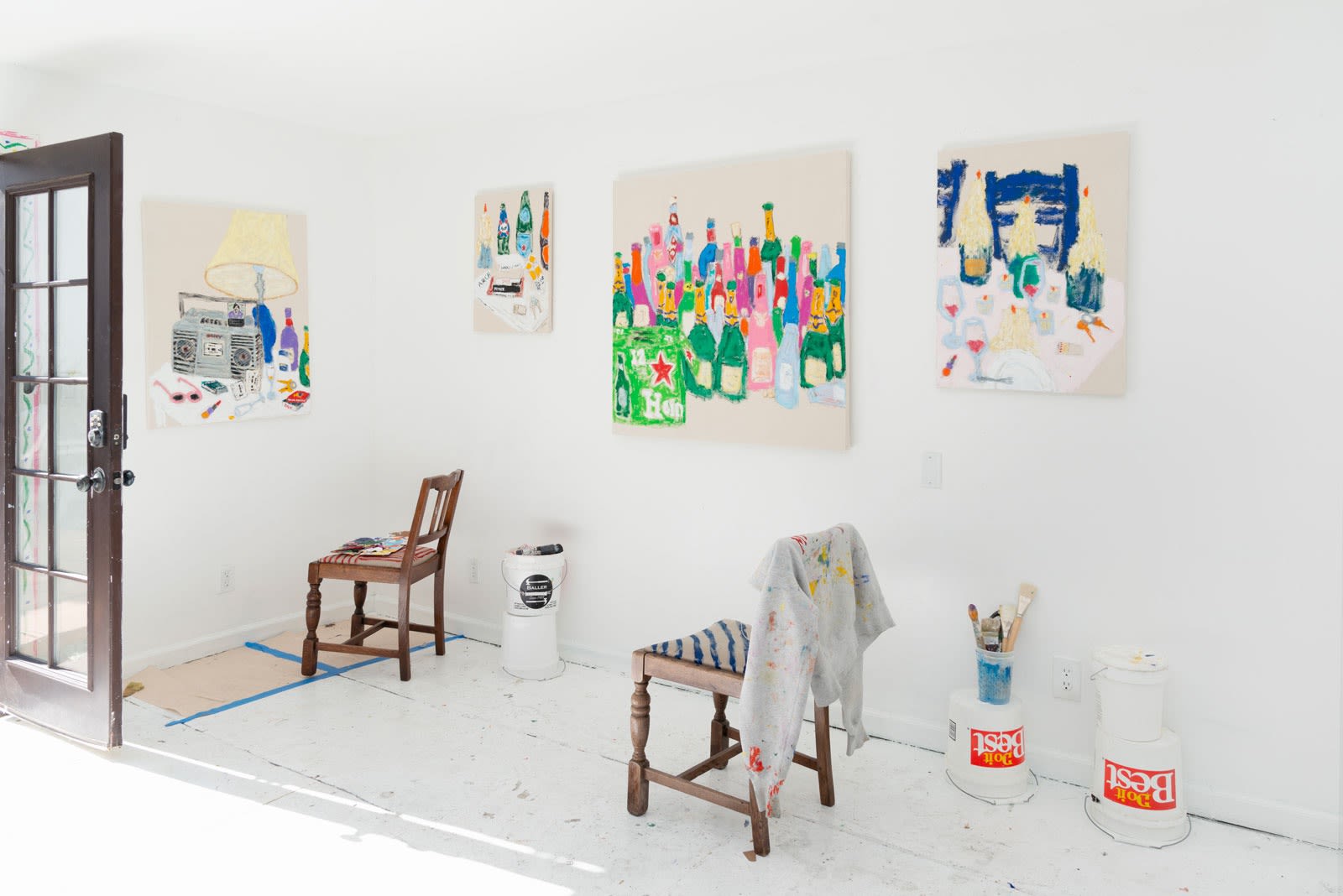 Michael McGregor studio with paintings and chairs 