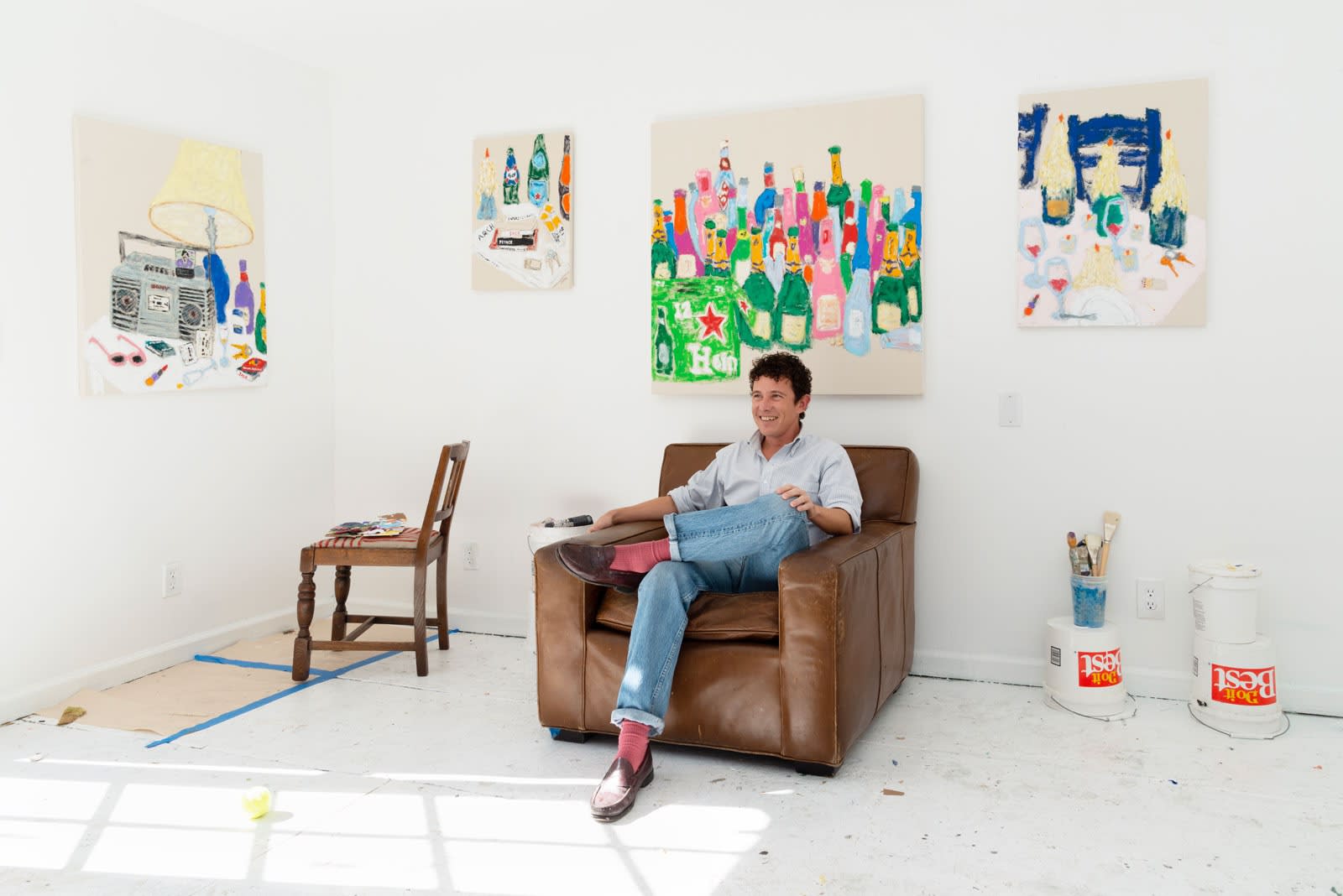 Michael McGregor sitting in an armchair in his studio 