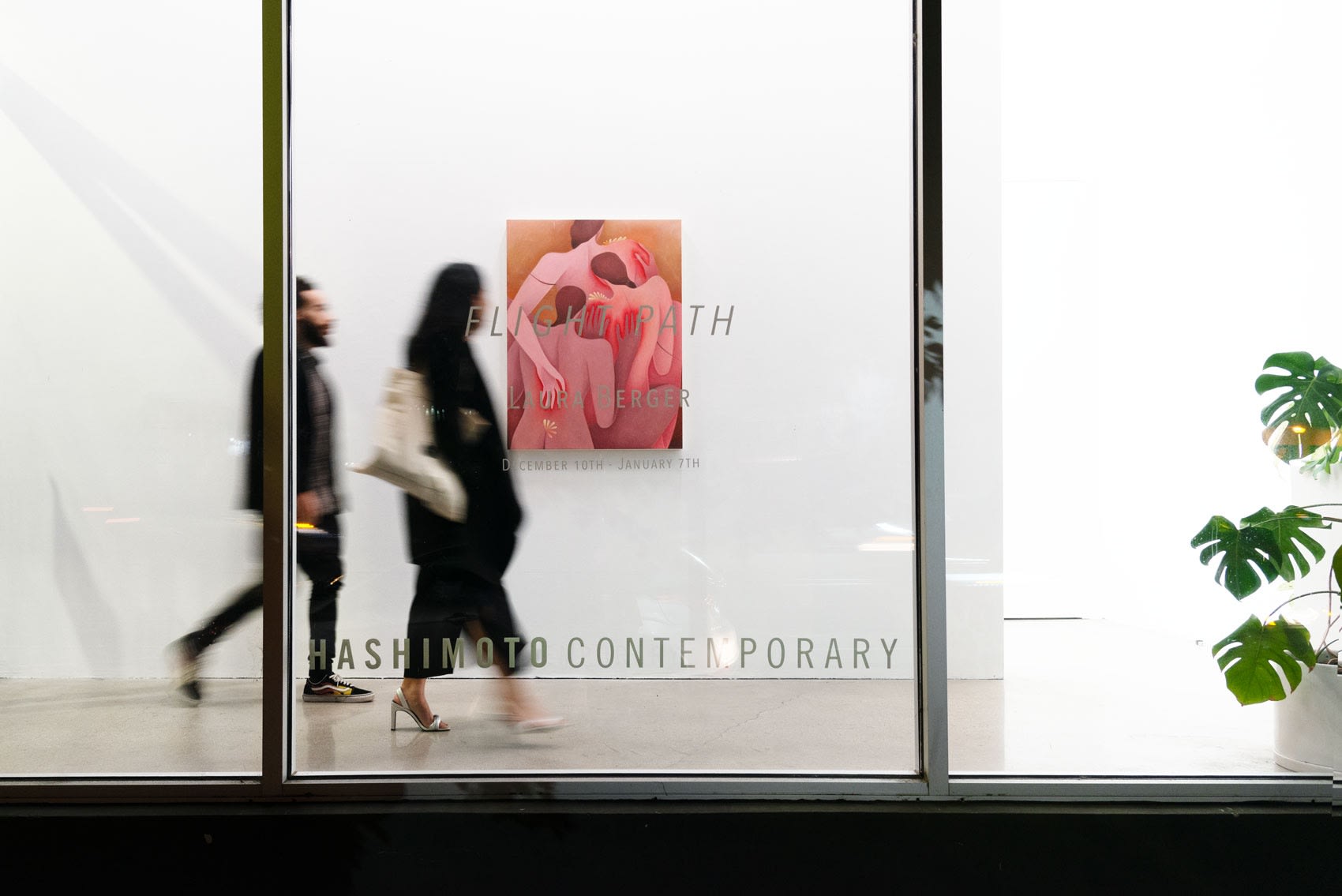 Image of people entering the gallery on opening night of Laura Bergers show at Hashimoto Contemporary LA walking past the front window with the show title on vinyl and Berger's painting in the back