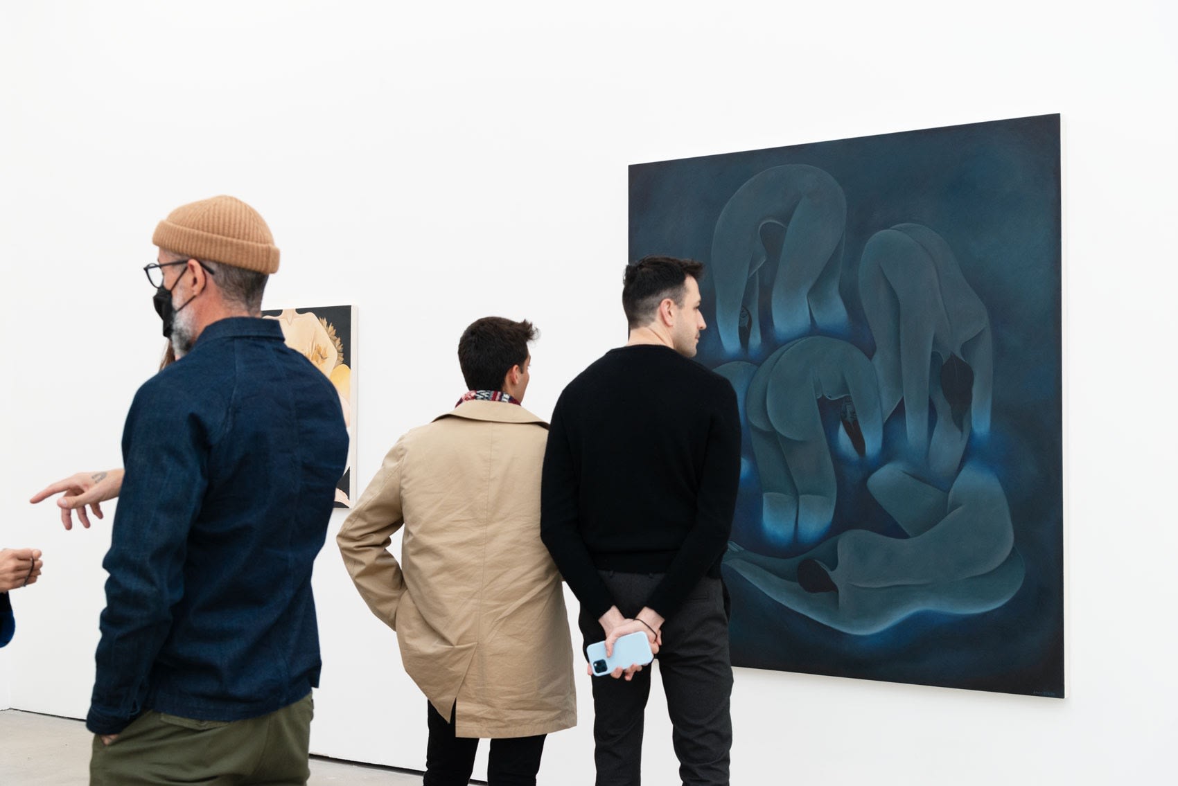 Image of two people looking at Laura Berger's painting 