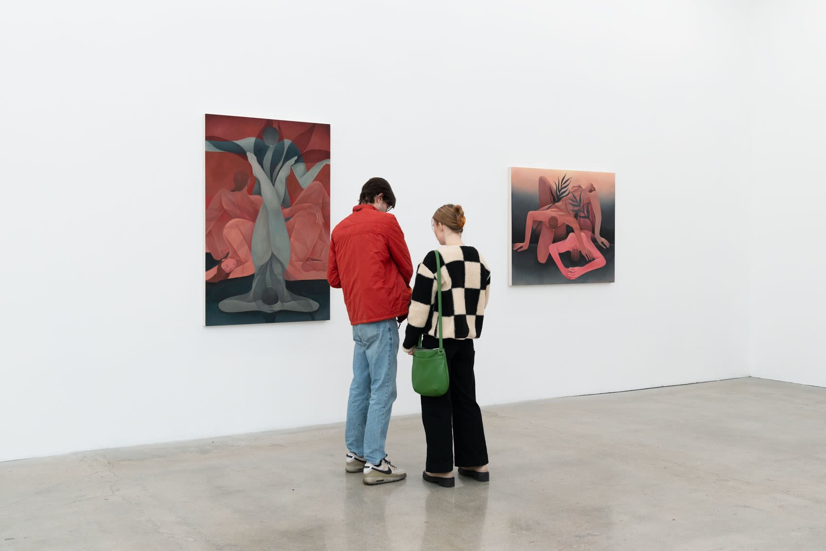 Image of two people looking at Laura Berger's painting 