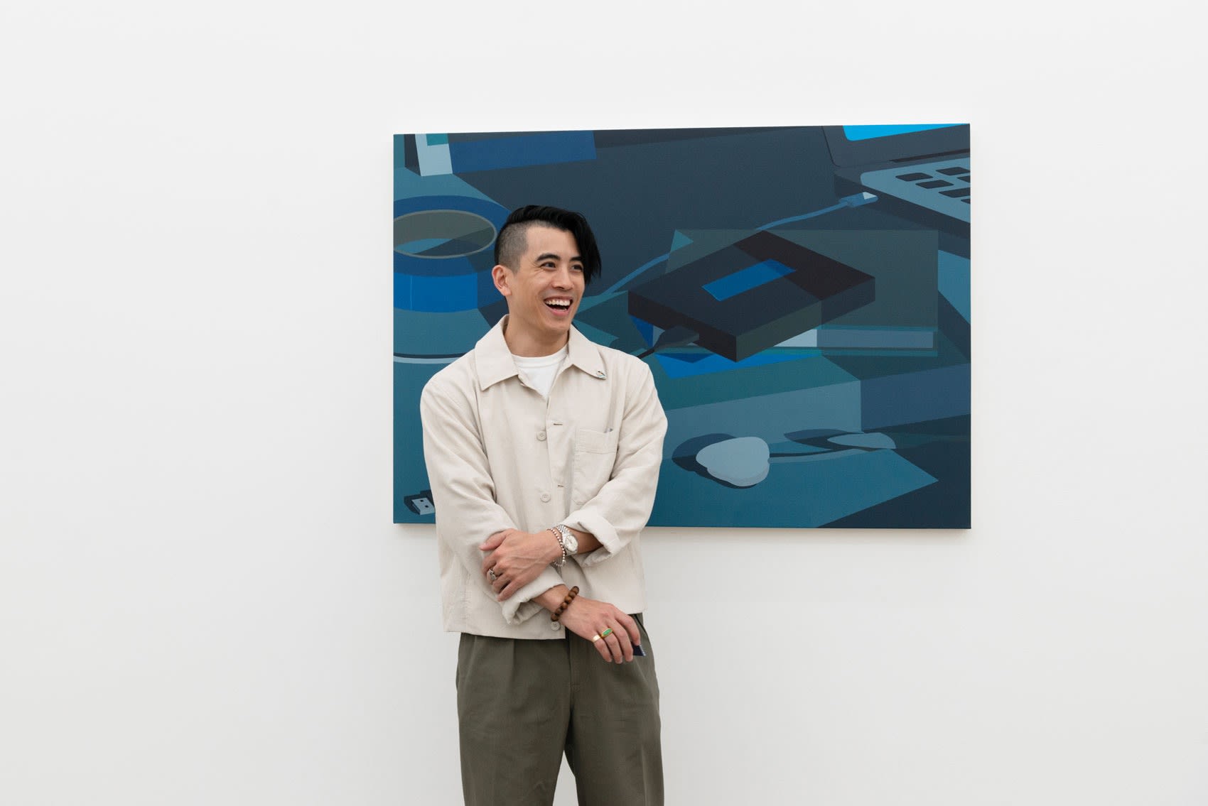 Artist Adrian Kay Wong in front of his painting Blue at the opening reception of Softly