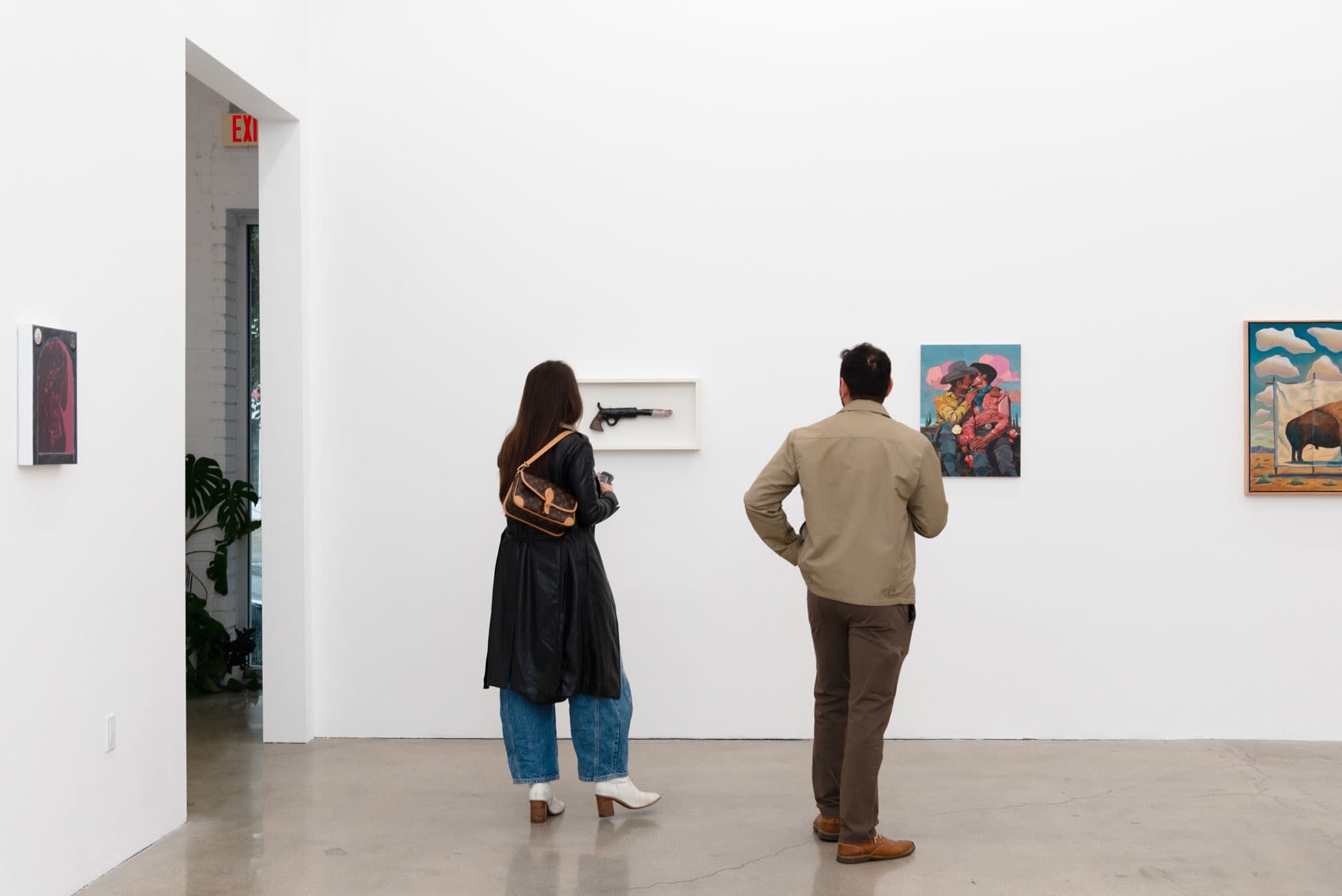 Two people looking at artwork on the wall