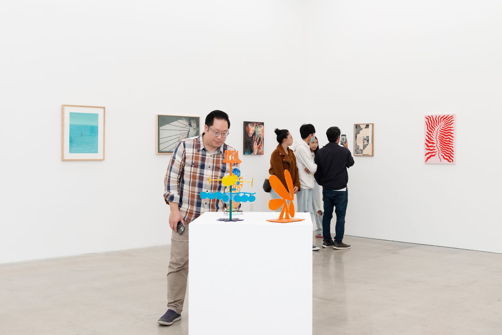A person looking at sculptures on a pedestal in the gallery at Hashimoto Contemporary LA