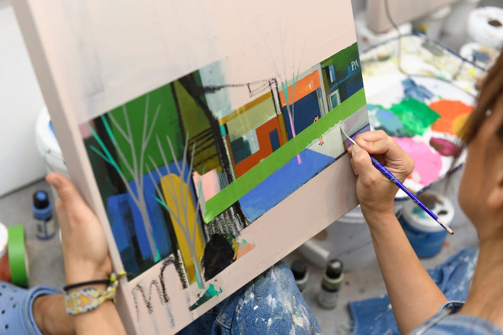 Seonna Hong painting in her studio 