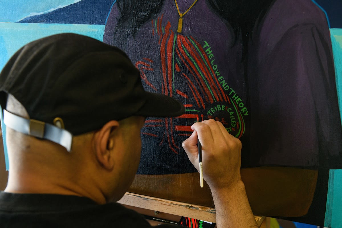 Photo of Dennis Brown painting in his studio