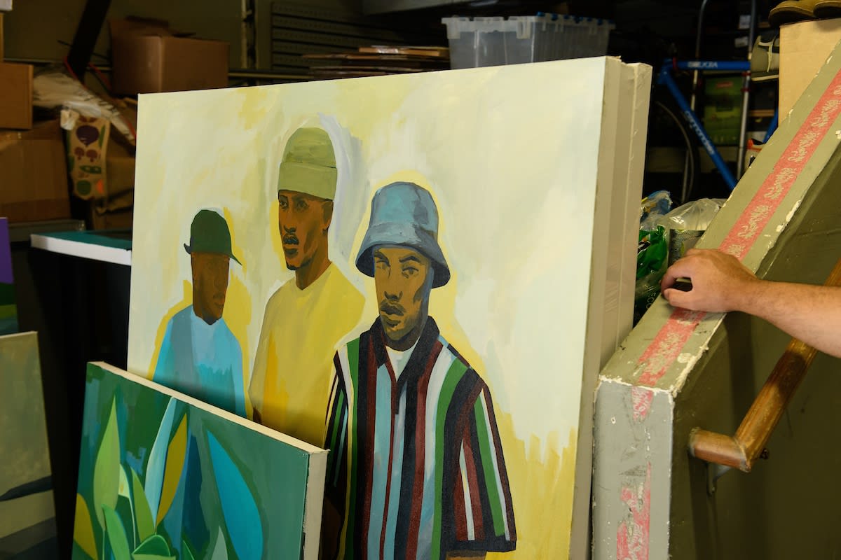 Photo of Dennis Brown painting in his studio