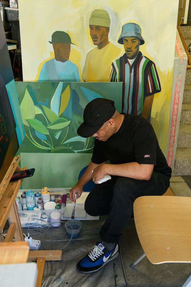 Photo of Dennis Brown painting in his studio