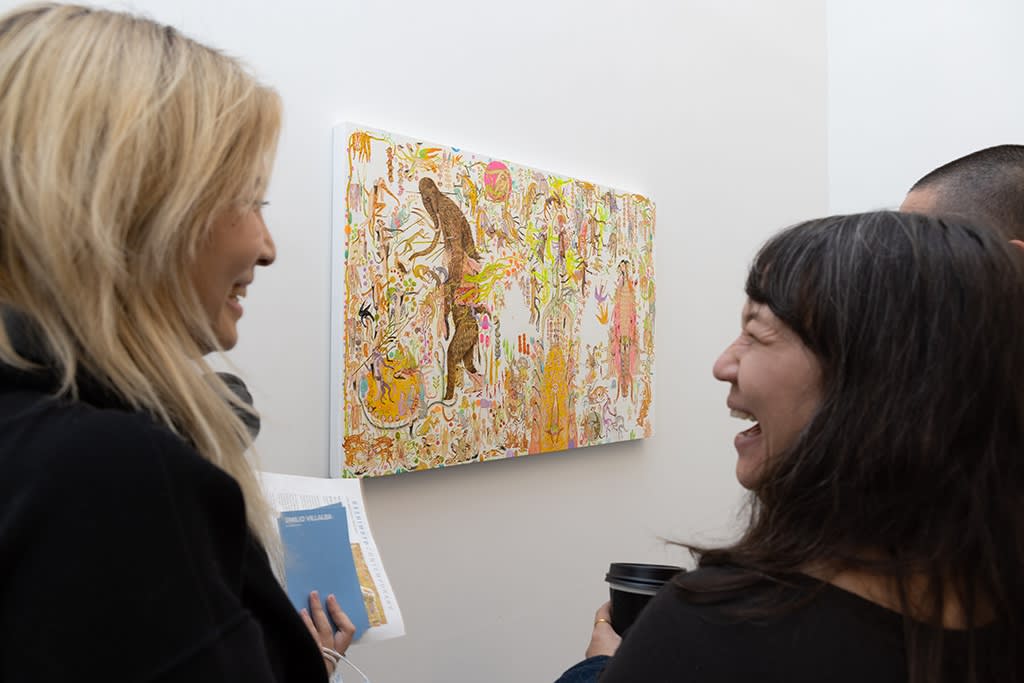 people in conversation laughing at the opening reception