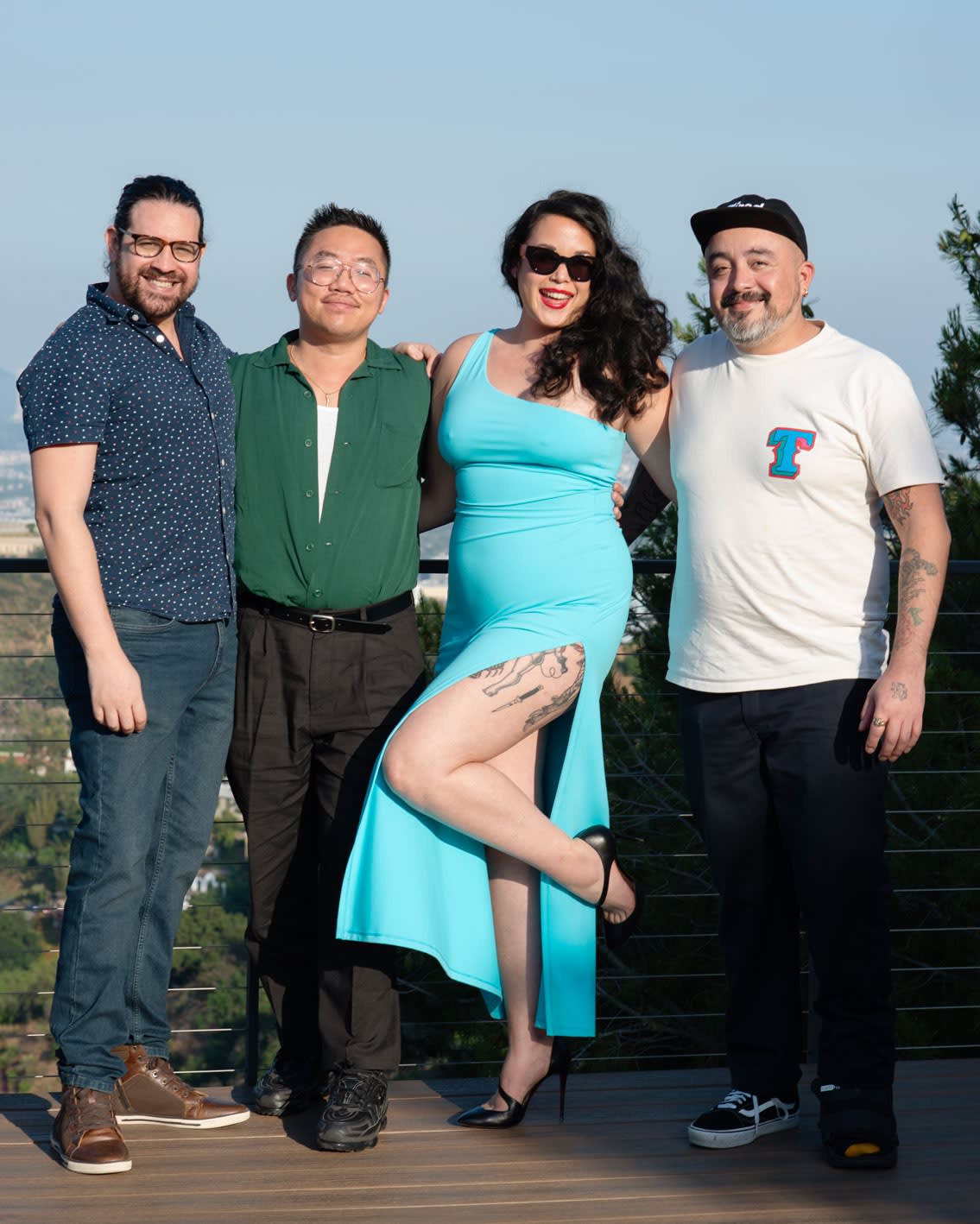 Carlos Rodriguez, Dasha Matsuura, Jean-Paul Mallozzi, and Justin Yoon standing on a deck outside in front of the Hollywood Hills