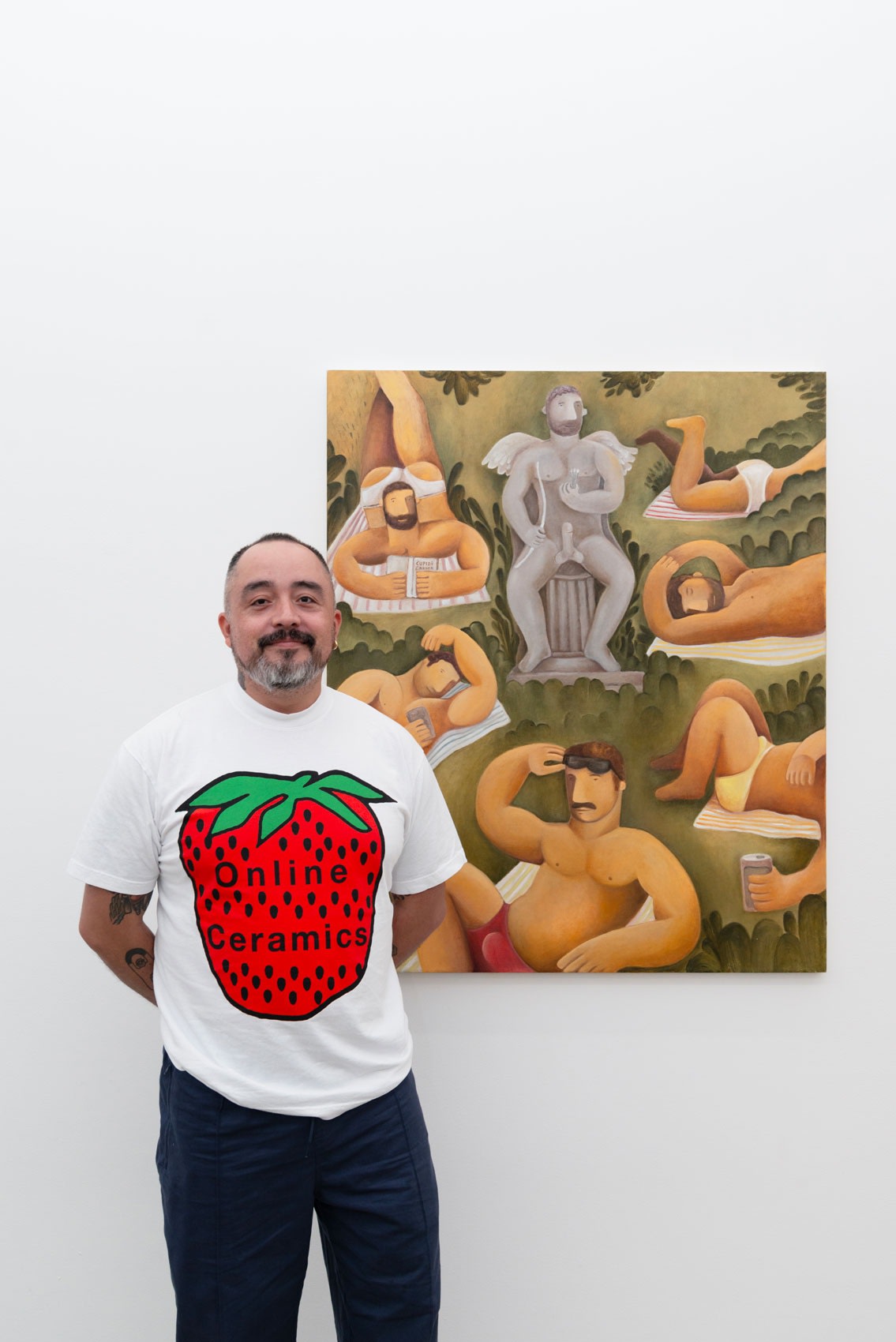 Artist Carlos Rodriguez posing in front of his work