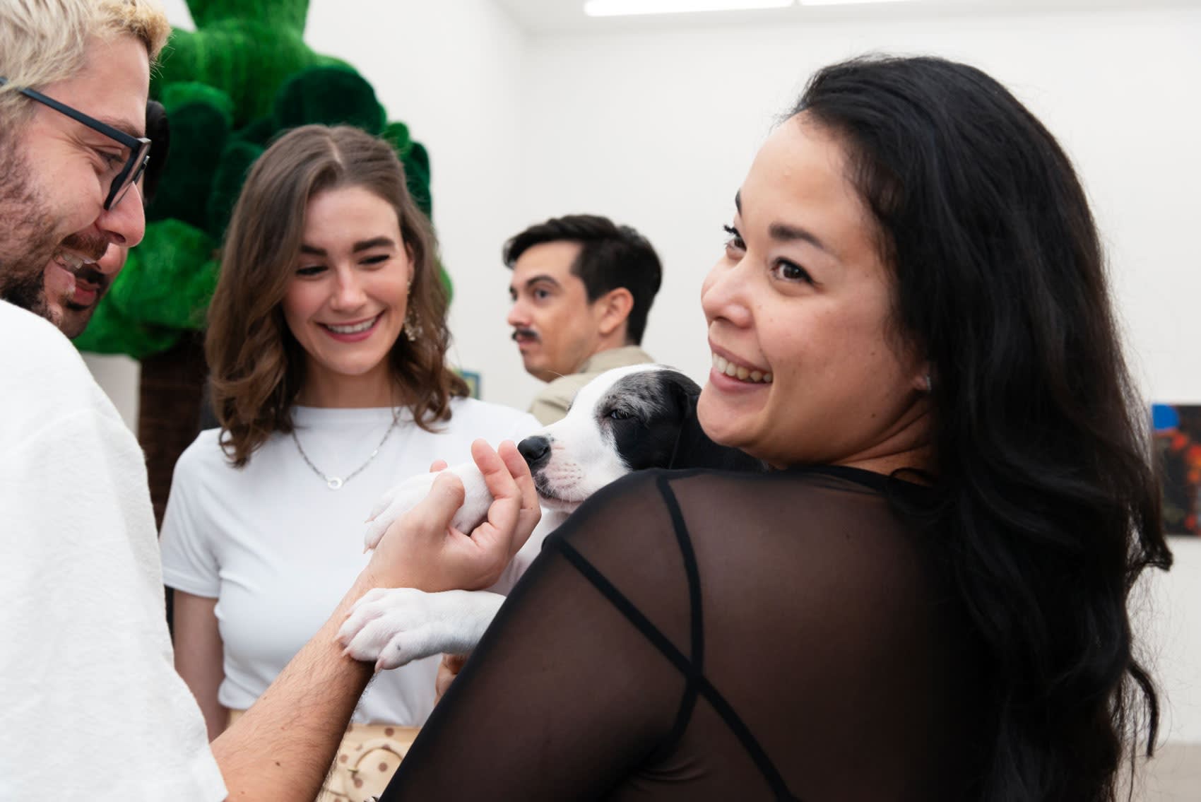 Artist thomas Martinez Pilnik and LA director Dasha Matsuura hold a puppy.